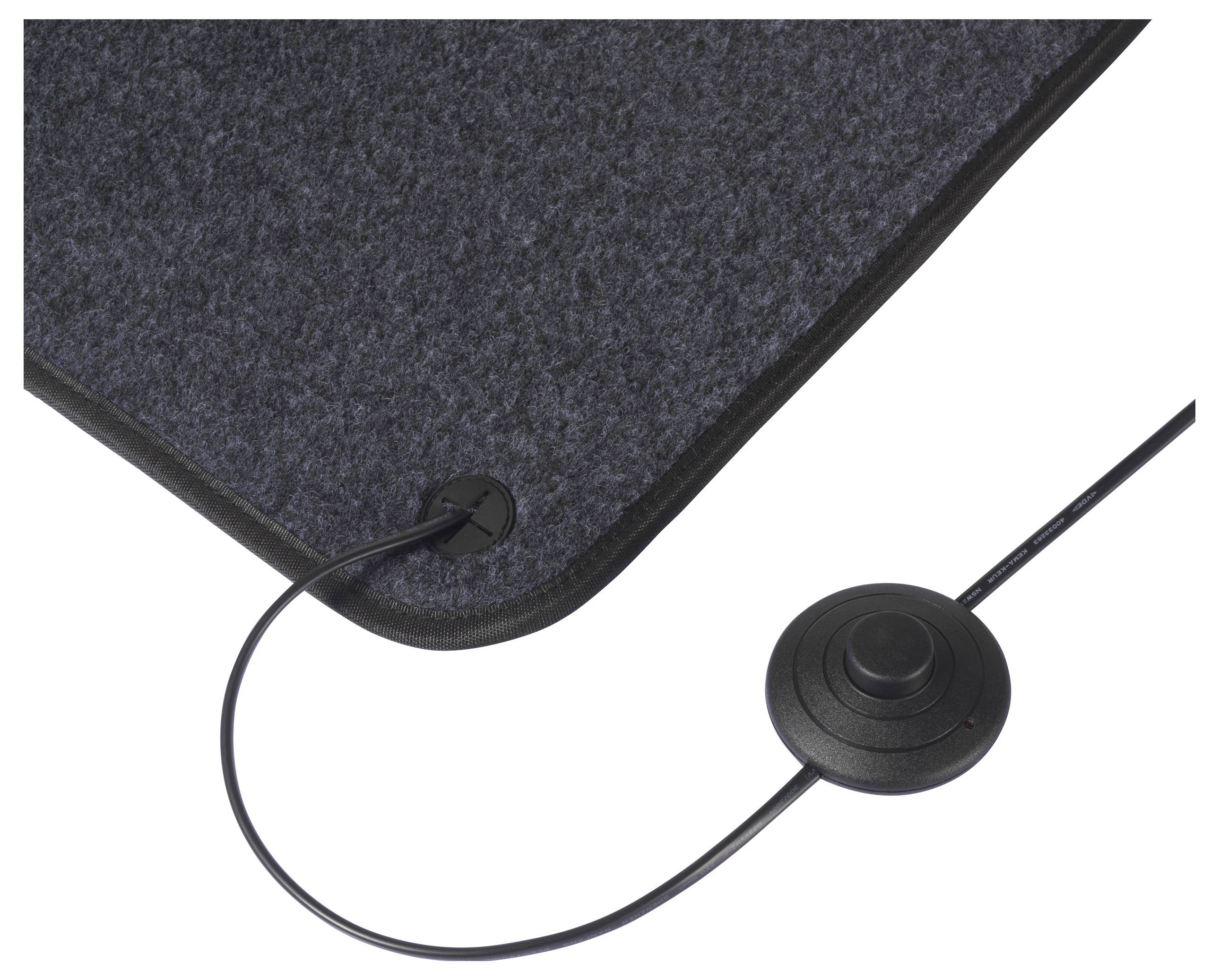 Eine Nahaufnahme einer dunkel gefärbten elektrischen Matte mit Kabel und rundem Bedienungsknopf, die zur Heizung oder zu therapeutischen Zwecken verwendet wird.