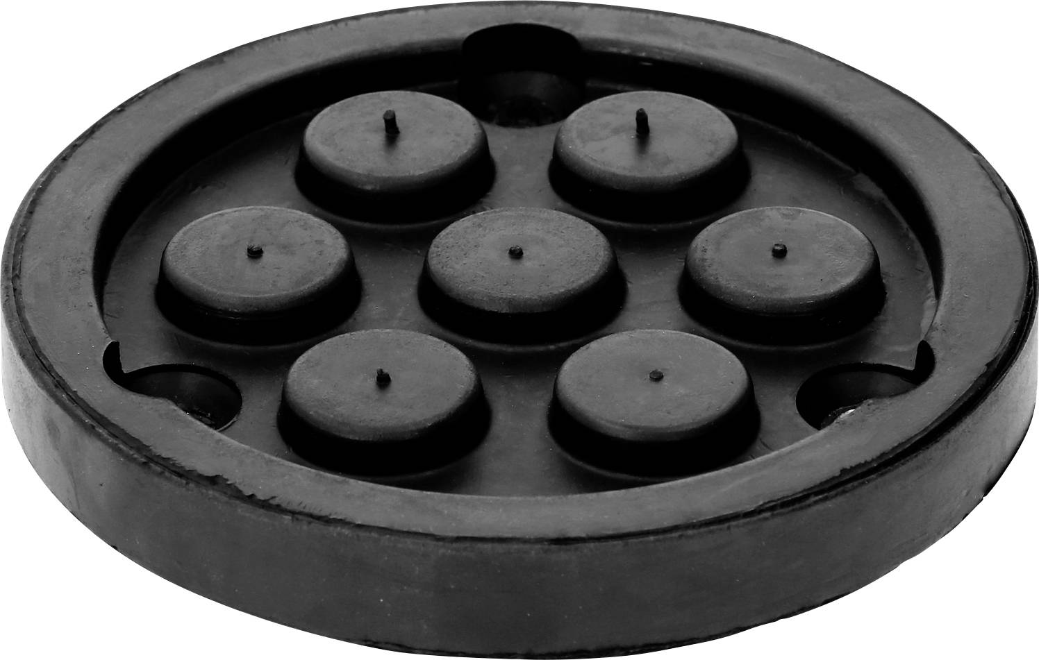 Schwarze, runde Gummischeibe mit sieben erhabenen Punkten auf der Oberseite, die ein Muster bilden.