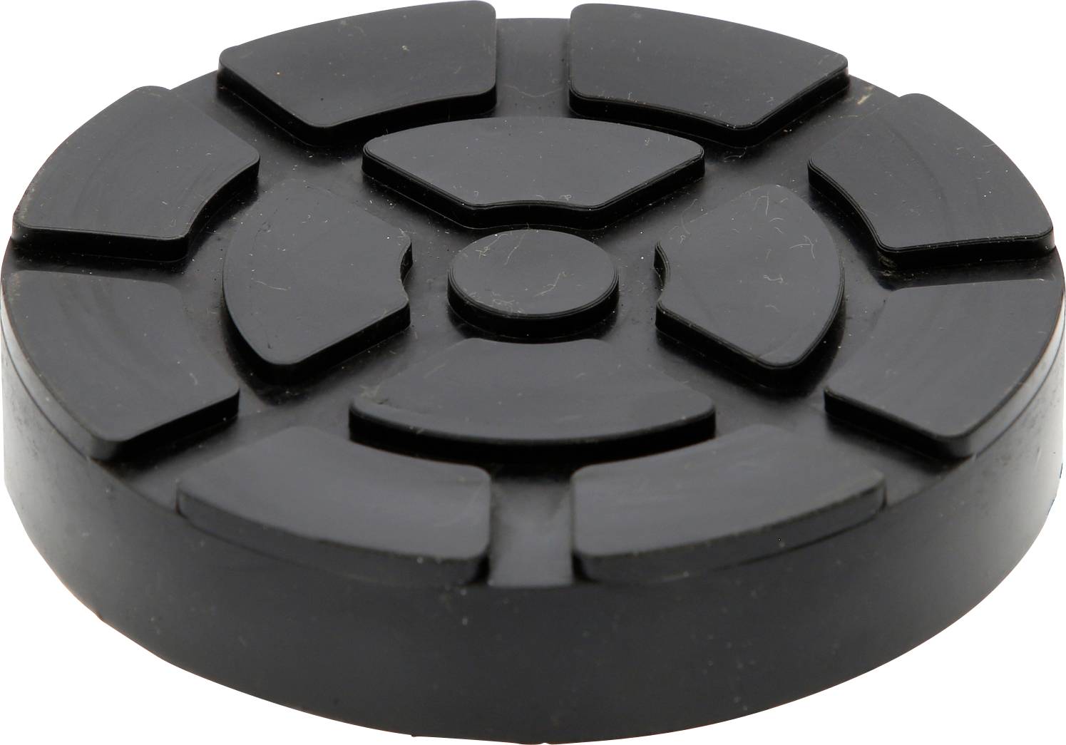Ein runder, schwarzer Gummipuck mit mehreren erhabenen, segmentierten Flächen. Verwendet als Polster gegen Vibrationen oder Geräusche.