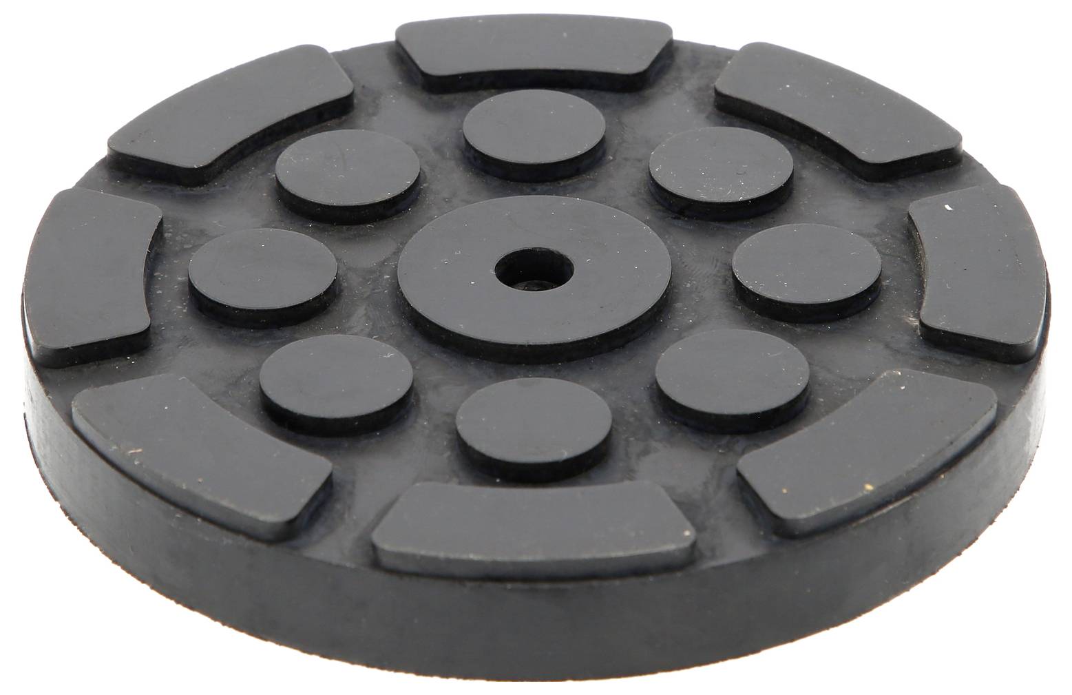 Runde, schwarze Gummischeibe mit erhobenen Streifen und Kreisen in symmetrischem Muster.