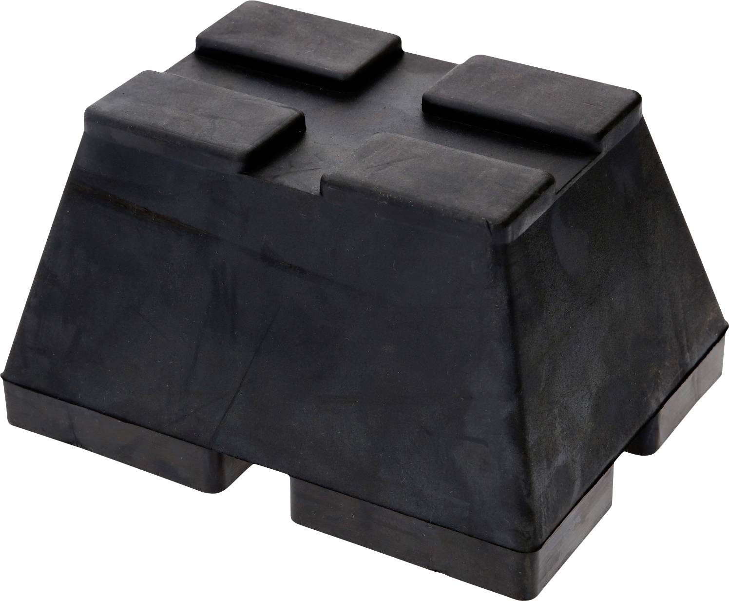 Ein schwarzer Keil aus Gummi mit vier rechteckigen Erhebungen auf der Oberseite und zwei an der Unterseite. Verschleißfester Baustoff.