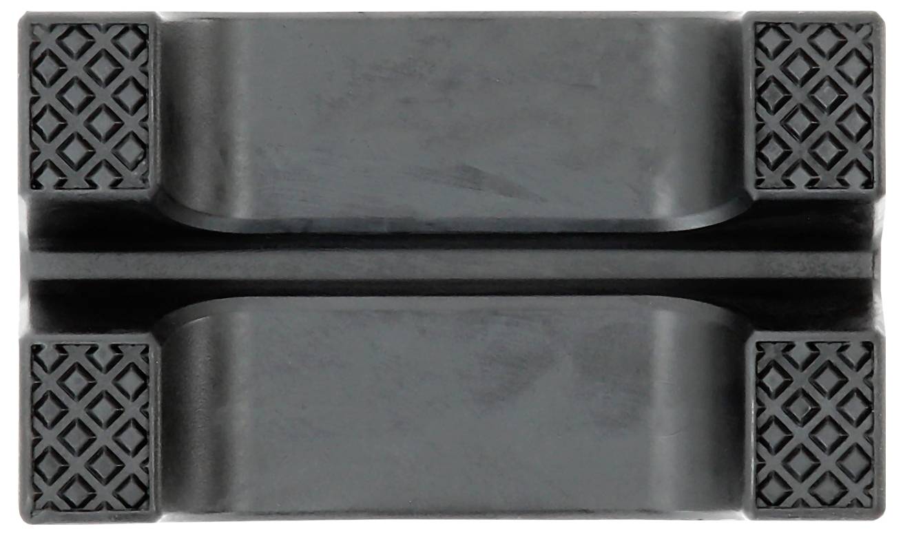 Graues, rechteckiges Objekt mit vier rutschfesten Gummiauflagen an den Ecken und einer Vertiefung in der Mitte.