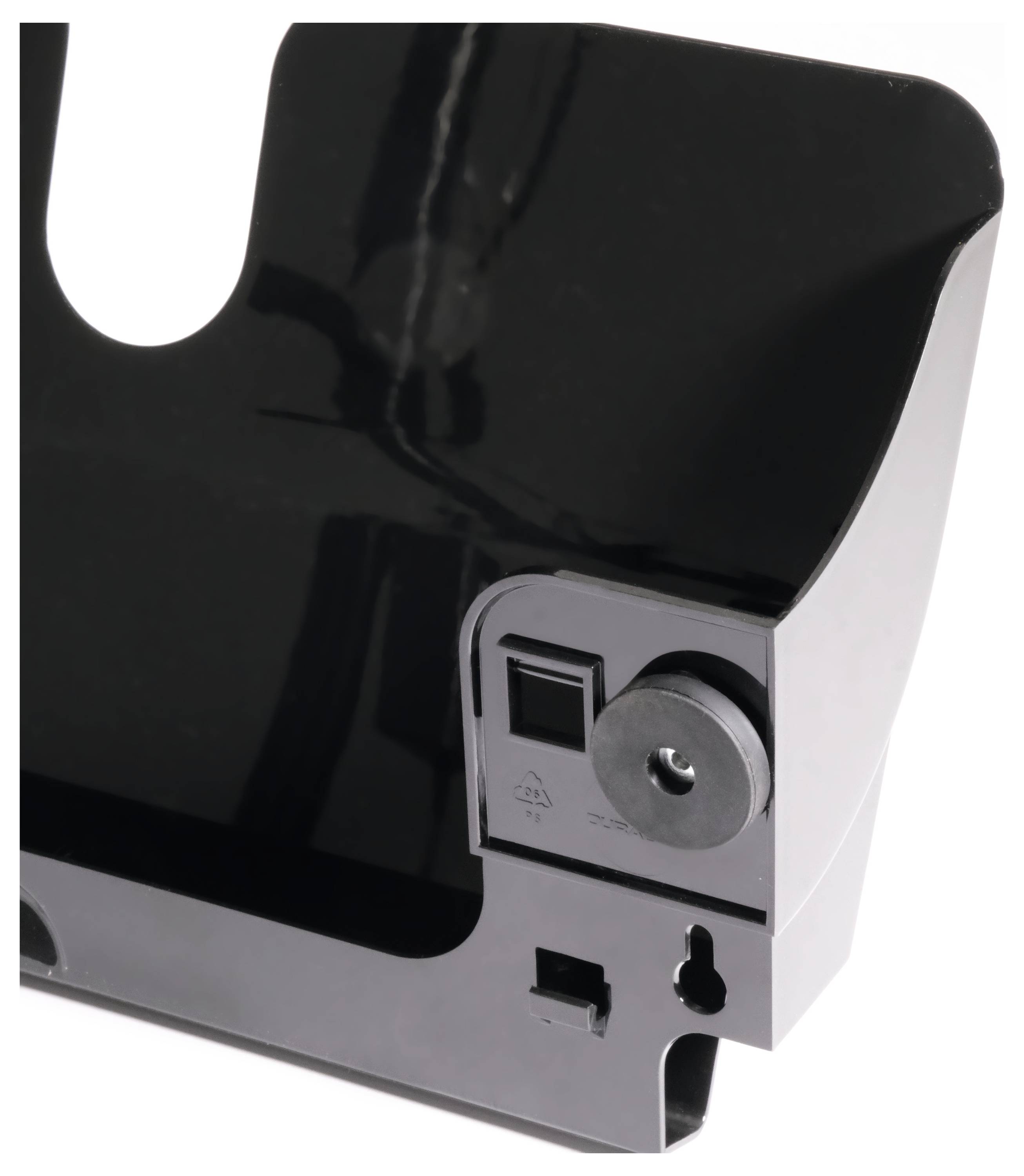 Ein schwarzes Kunststoffelement mit einer runden Öffnung und rechteckigen Aussparungen. Es scheint ein Teil eines mechanischen Systems zu sein.