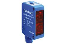 Ein blauer optischer Sensor der Marke 'Contrinex', Modell LRE-303PA-P18-501, mit rotem Lichtfenster, verwendet für die Objekterkennung.