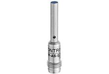 Zylinderförmiges Metallteil mit kleiner Öffnung und Gravur 'CONTRINEX DW-AS-6'. Wahrscheinlich ein elektronischer Sensor oder Bauteil.