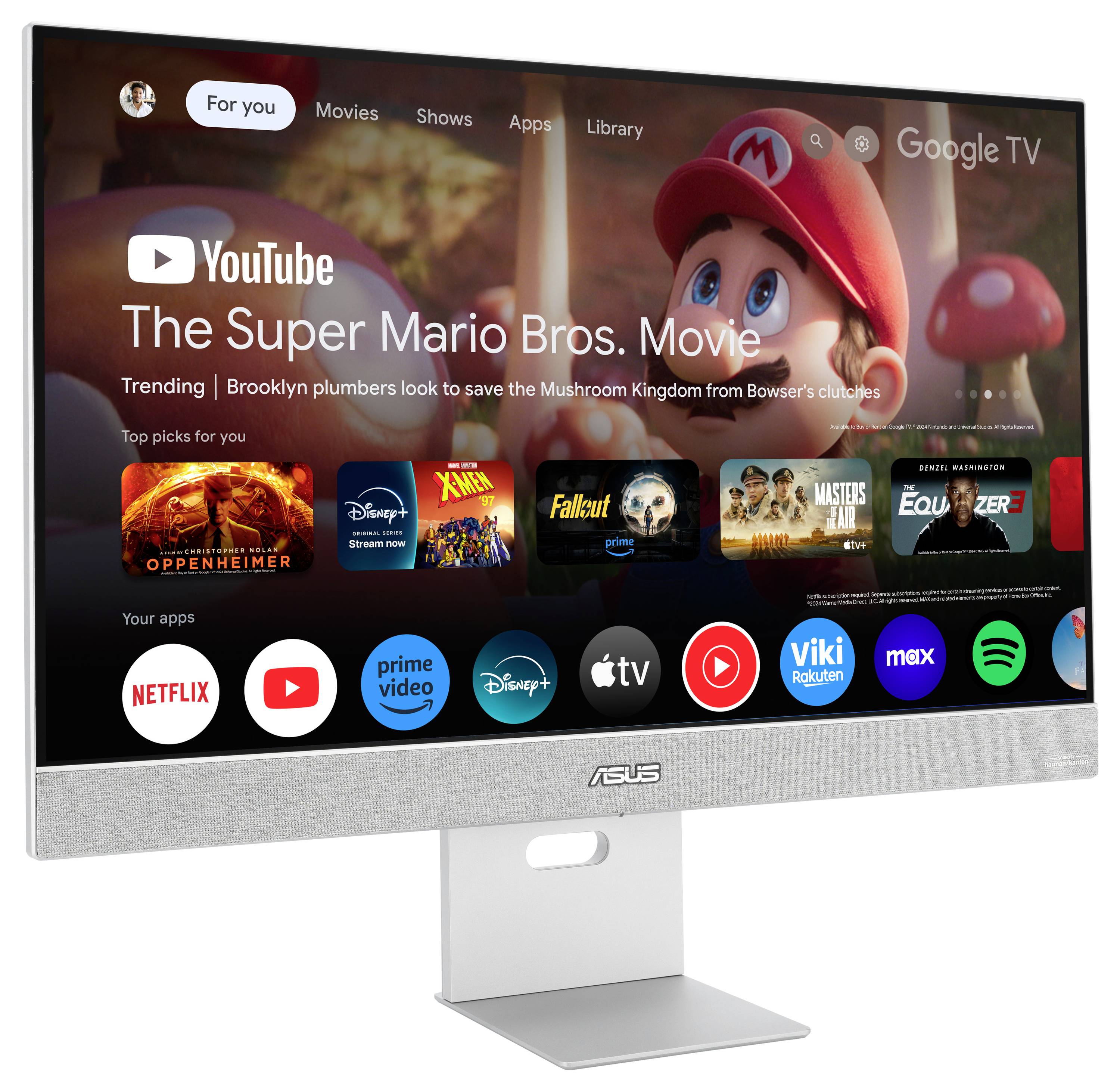 Ein Monitor zeigt Google TV mit 'The Super Mario Bros. Movie'. Darunter sind verschiedene Streaming-Apps wie Netflix, Prime Video und Disney+.
