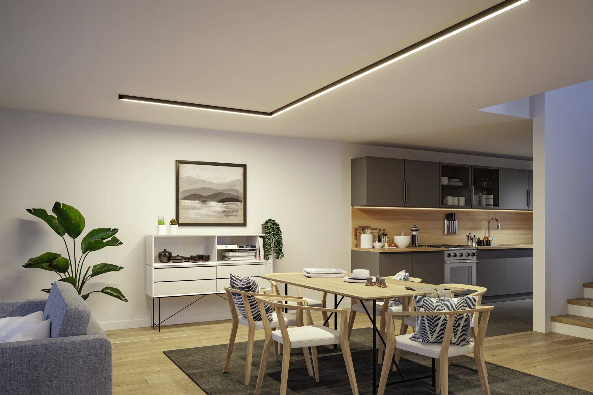 Lichtdurchflutetes Wohnzimmer mit Essbereich und offener Küche, modernem Tisch, Stühlen, Sofa, Pflanze und Wanddekoration.