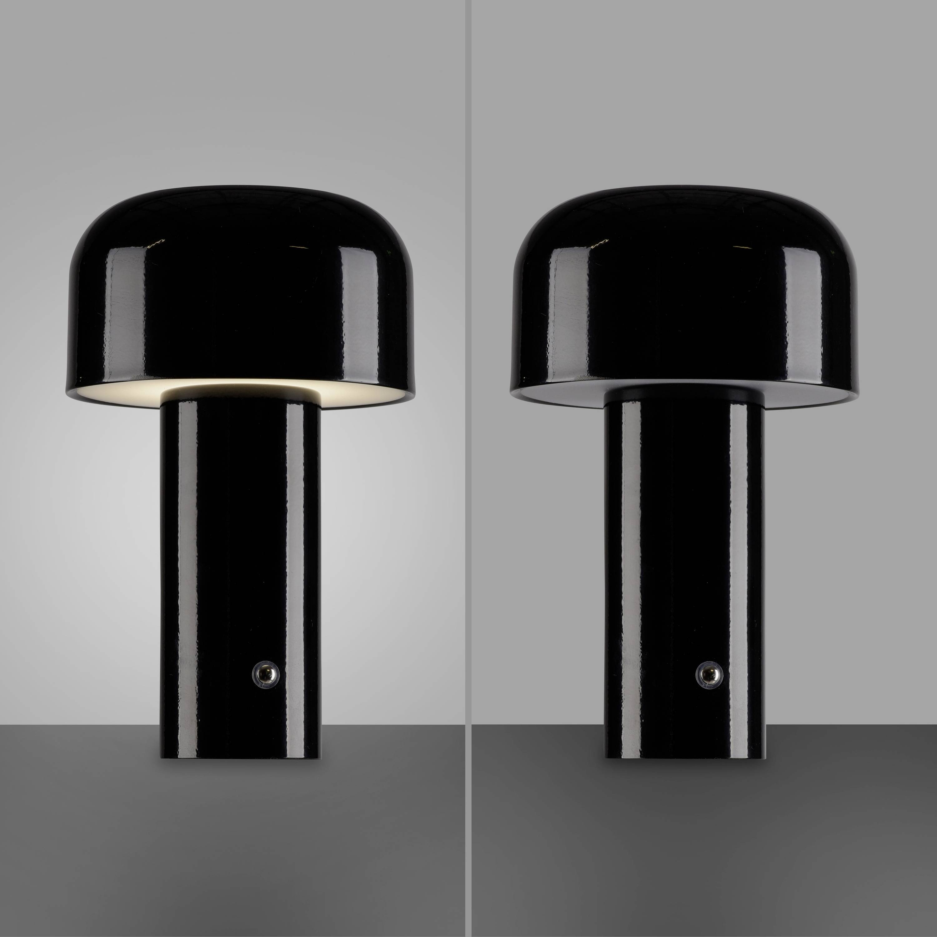 Zwei schwarze Tischlampen mit gewölbtem Schirm; links leuchtet, rechts ausgeschaltet. Beide auf grauem Hintergrund.