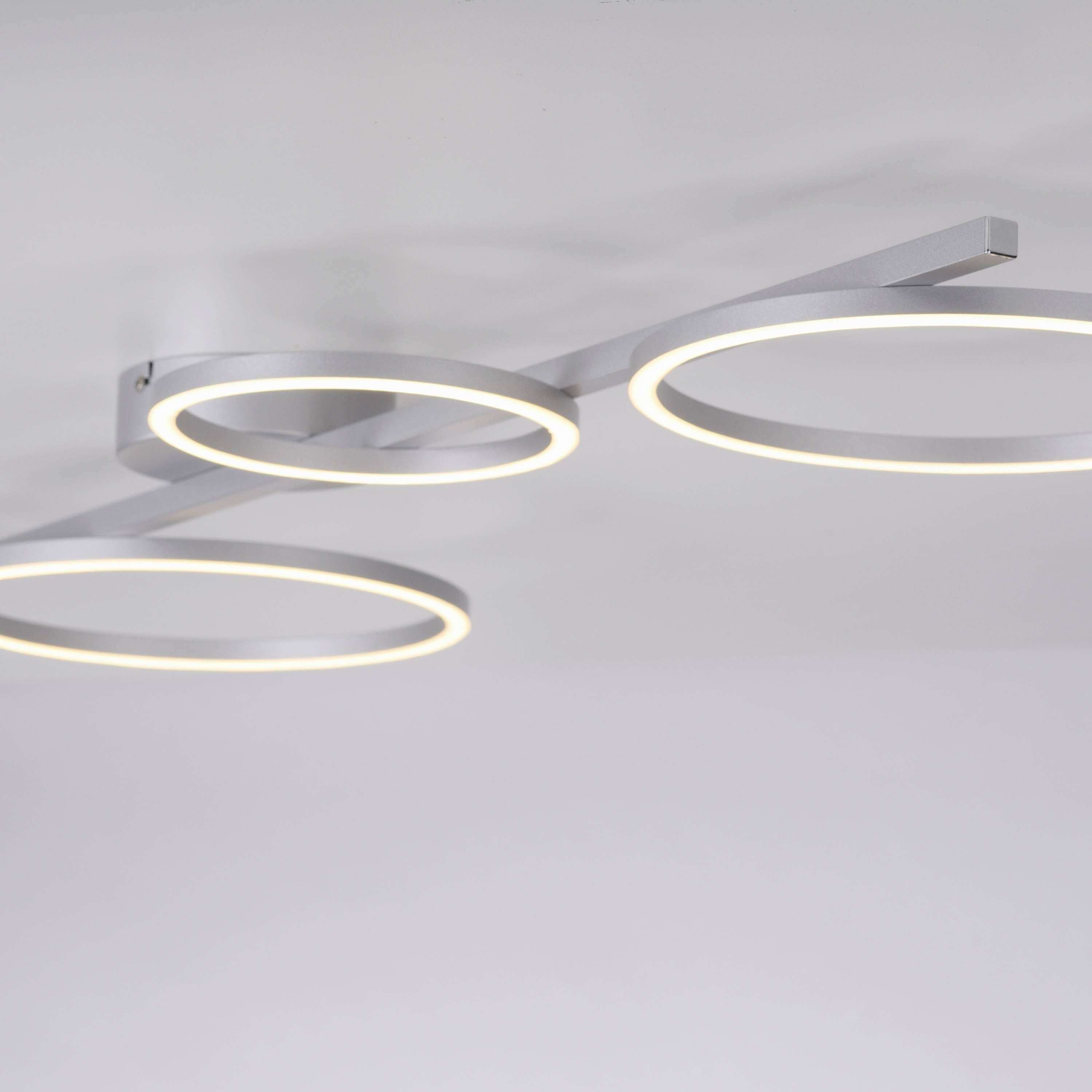 Drei moderne, ringförmige LED-Deckenleuchten aus Metall, die minimalistisch und elegant gestaltet sind und warmweißes Licht ausstrahlen.