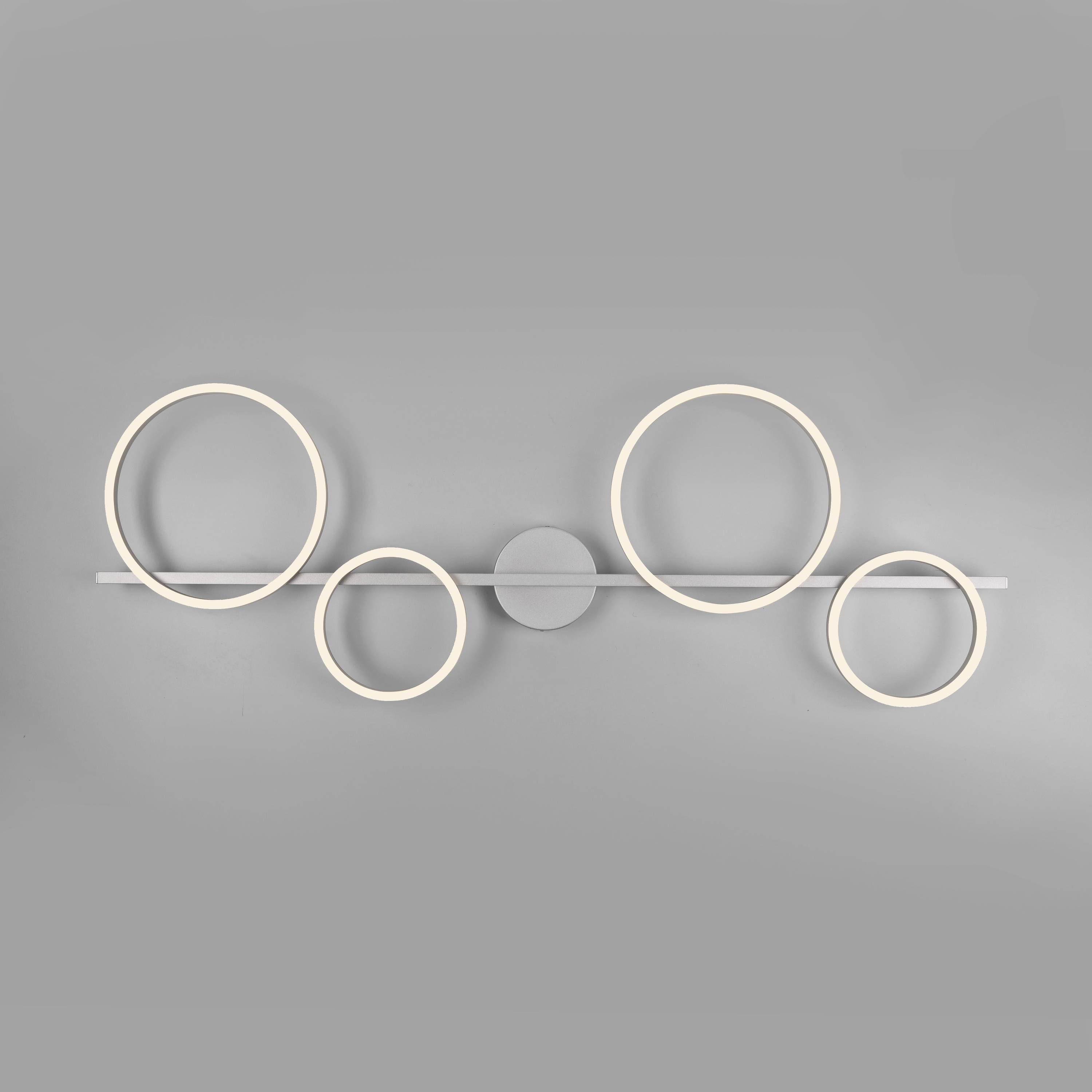 Eine moderne LED-Wandleuchte mit fünf leuchtenden Kreisen unterschiedlicher Größe auf einem horizontalen Balken.