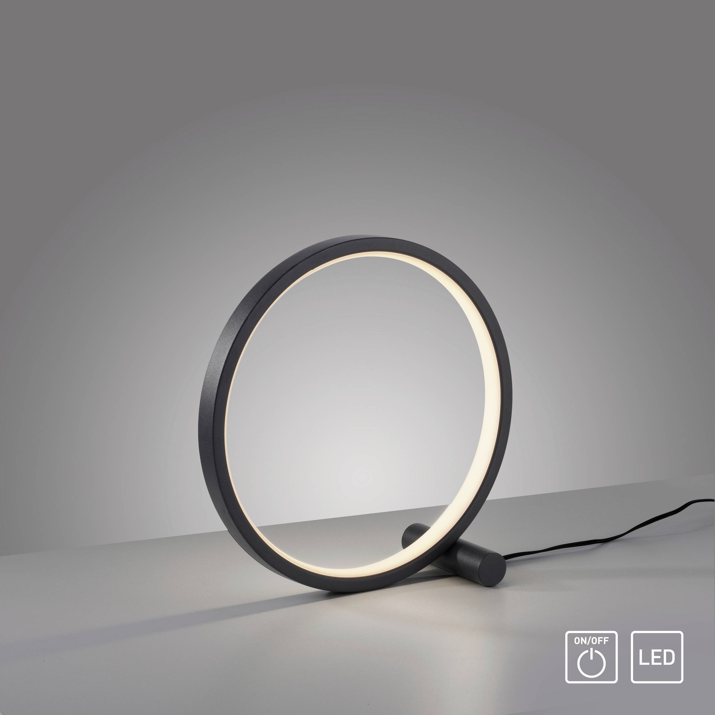 Runde Tischlampe mit minimalistischem Design, schwarzem Rahmen und integriertem LED-Licht, leuchtet auf neutralem Hintergrund.