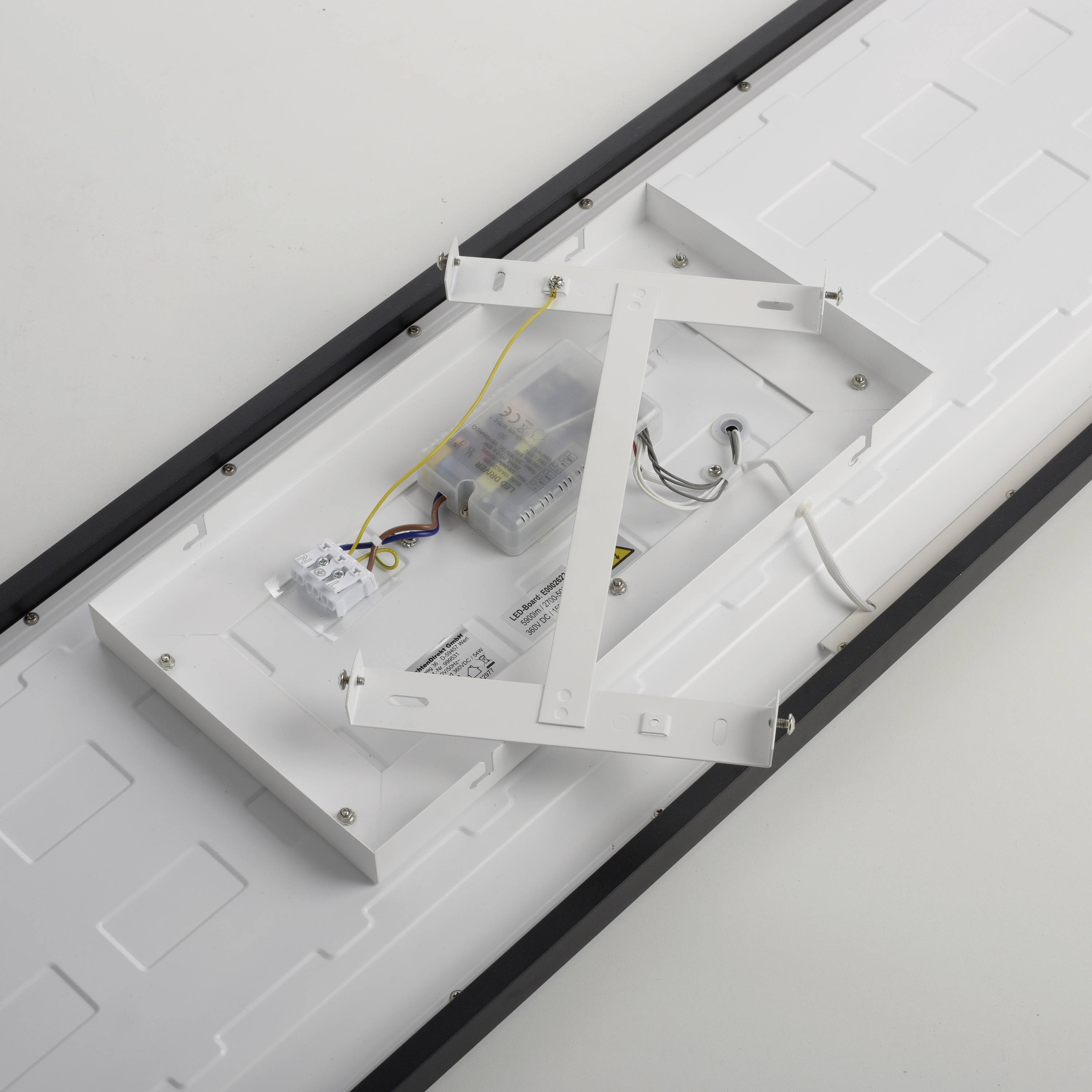 Rückansicht einer rechteckigen LED-Deckenleuchte mit geöffneter Abdeckung, sichtbaren Kabeln und Halterungen zur Befestigung.