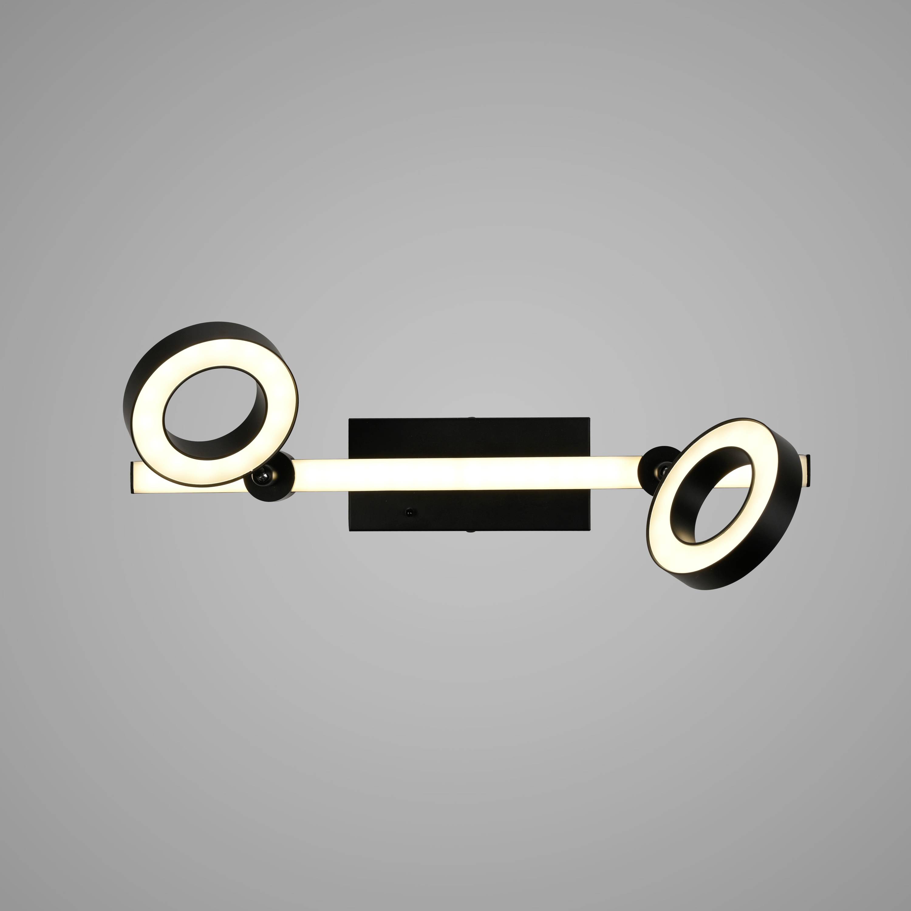 Moderne Wandlampe mit zwei kreisförmigen LED-Leuchten auf einem Metallbalken, hängt an grauer Wand.