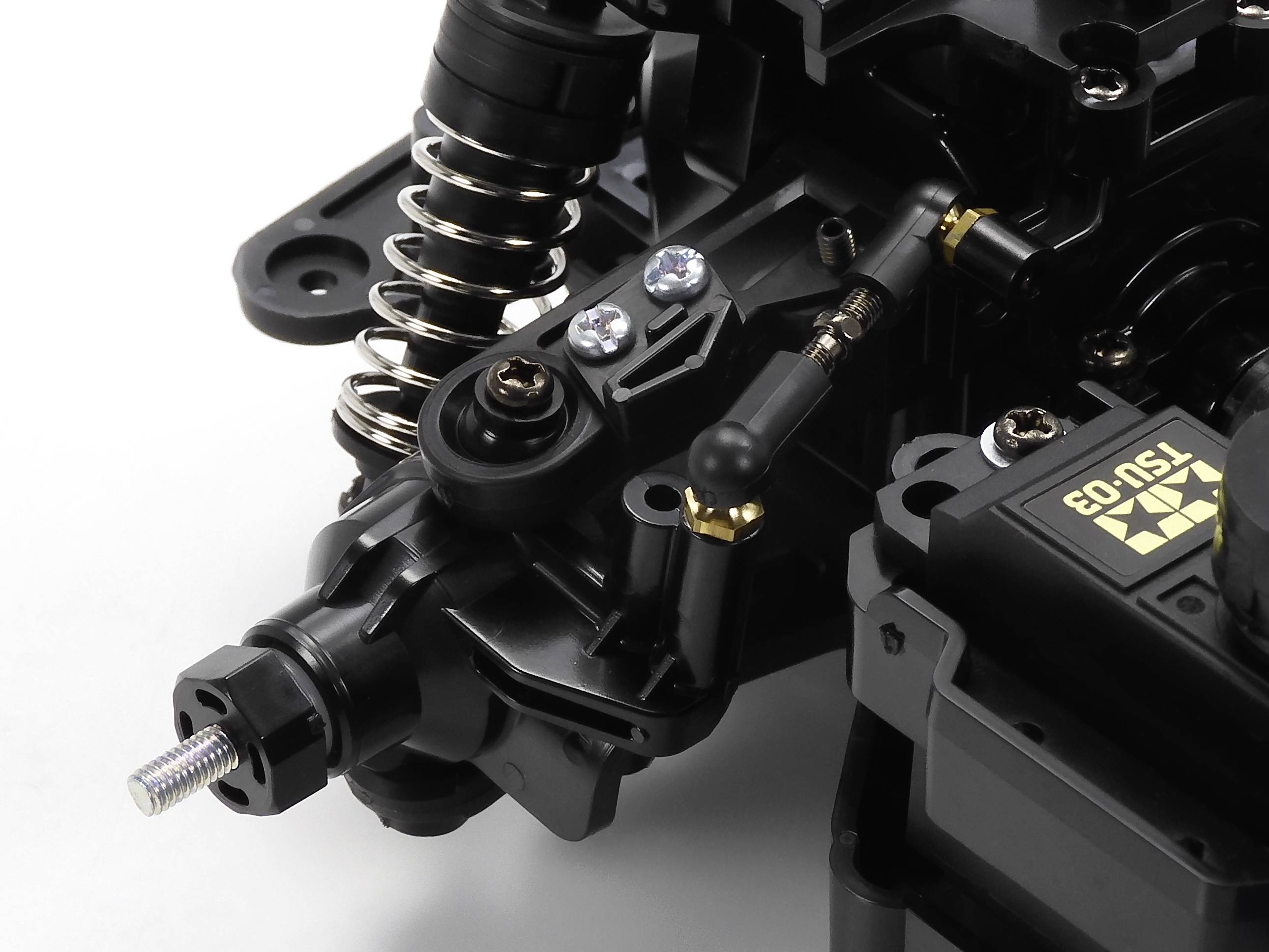 Nahaufnahme eines mechanischen Teils mit Federn und verschraubten Komponenten, möglicherweise Teil eines Fahrzeugs oder technischen Geräts.