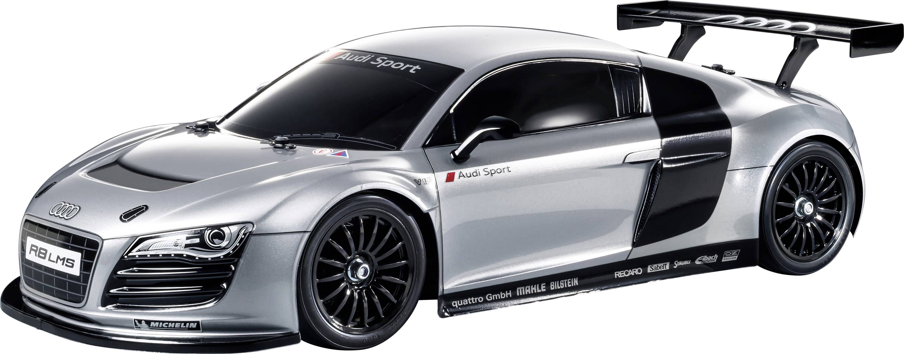 Silberner Sportwagen mit auffälligen Aerodynamik-Komponenten wie großer Heckspoiler und Lüftungsschlitzen, Seitenansicht.
