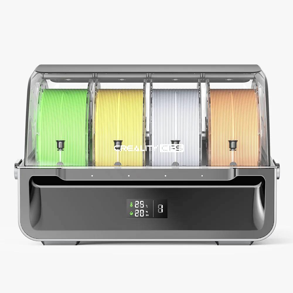 3D-Druck-Filamenttrockner mit vier transparenten Kammern, die grüne, gelbe, graue und orangefarbene Filamente enthalten. LED-Anzeige unten zeigt Temperatur.