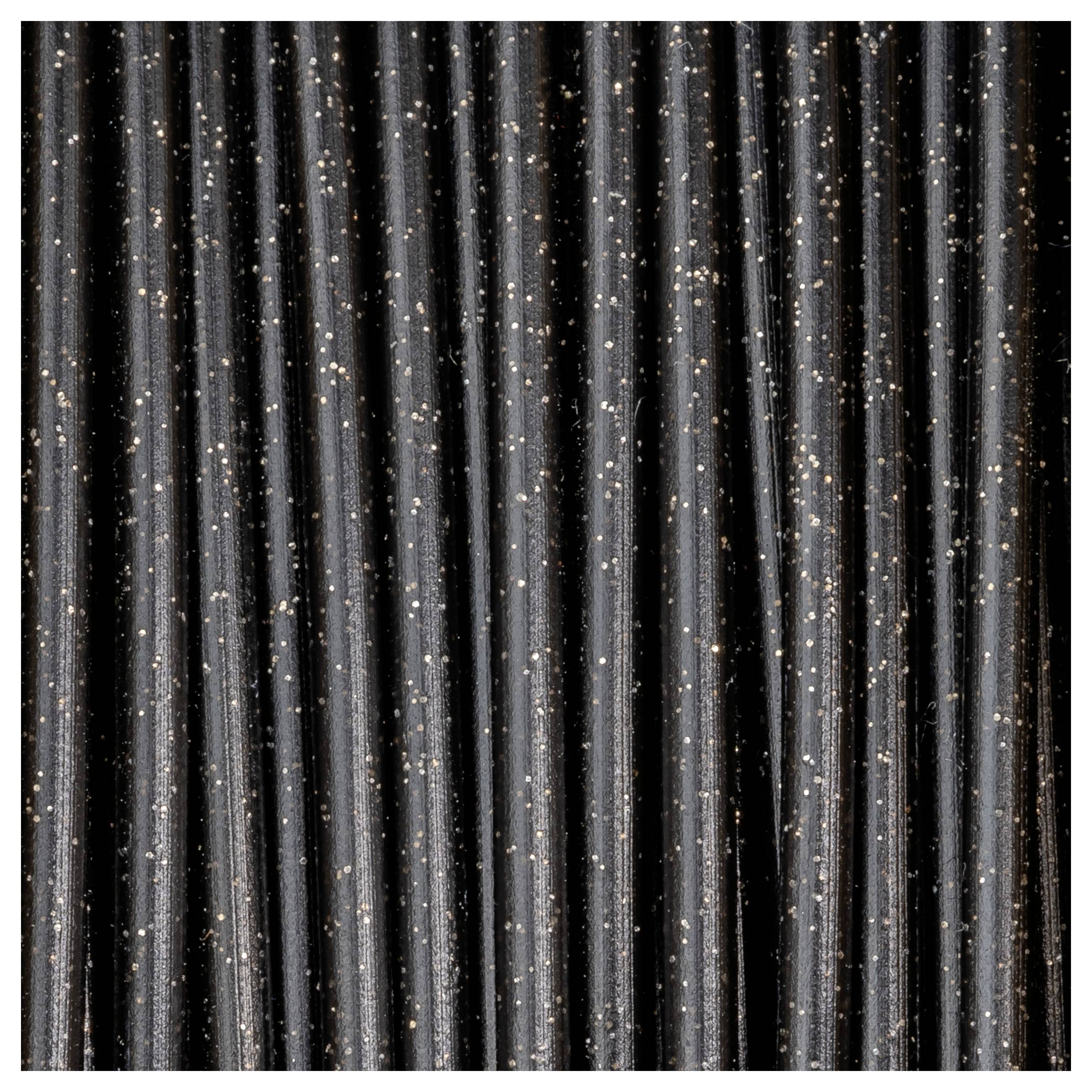 Nahaufnahme von schwarzen Stäben mit kleinen, reflektierenden Punkten, die gleichmäßig verteilt sind. Die Oberfläche wirkt strukturiert.