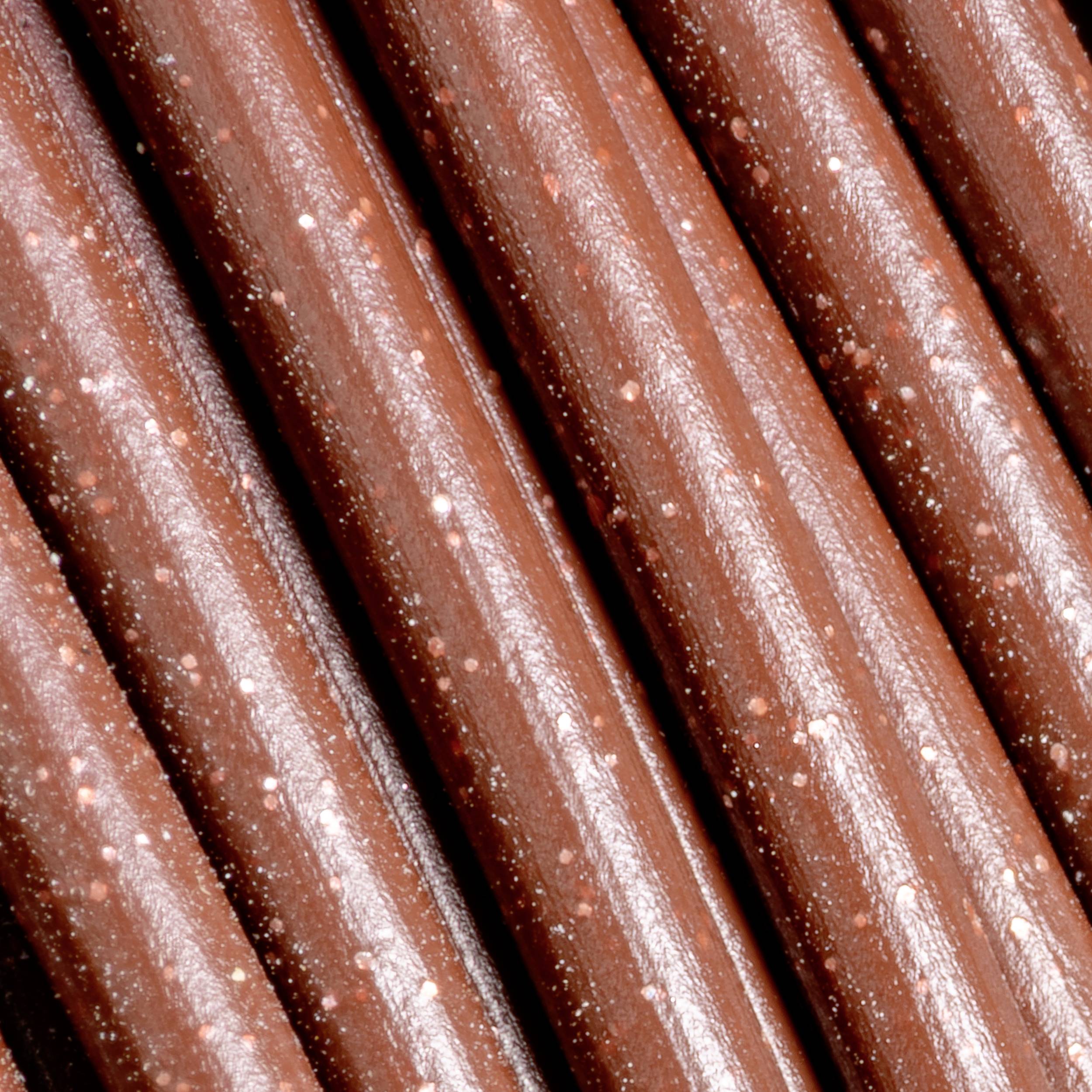 Nahaufnahme mehrerer brauner Holzstifte, die parallel zueinander liegen. Sie haben eine glänzende Oberfläche und kleine weiße Flecken.