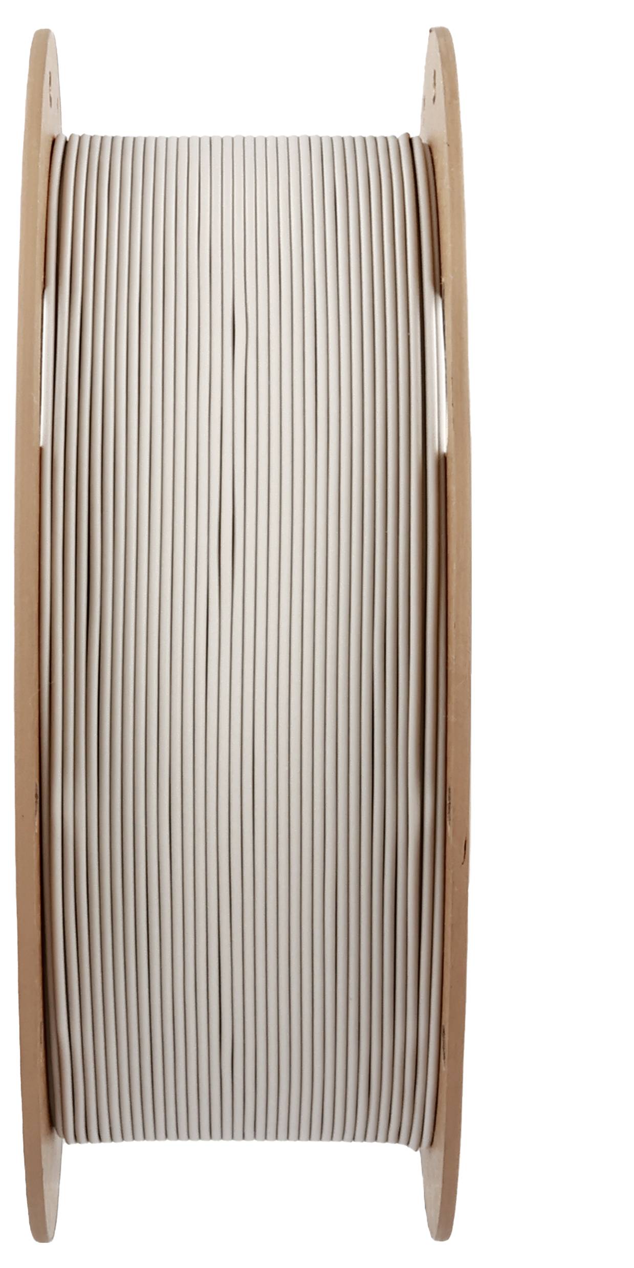 Große Holzspule mit aufgewickeltem weißen Kabel.