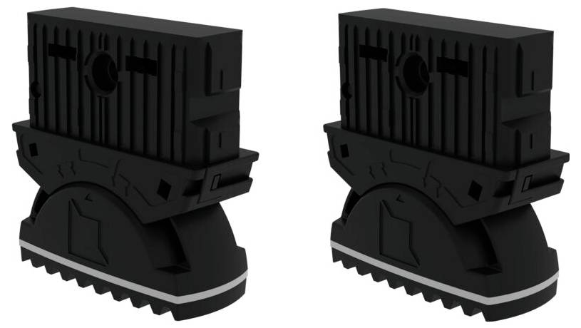 Zwei schwarze Kunststoffteile mit zahnähnlicher Struktur und kreisförmiger Öffnung oben. Sie dienen zur Verbindung oder Befestigung.