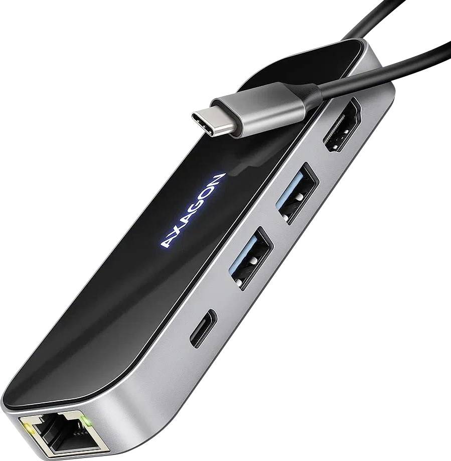 Ein schwarzer Adapter mit mehreren USB- und HDMI-Anschlüssen, verbunden mit einem USB-C-Kabel. Markenname 