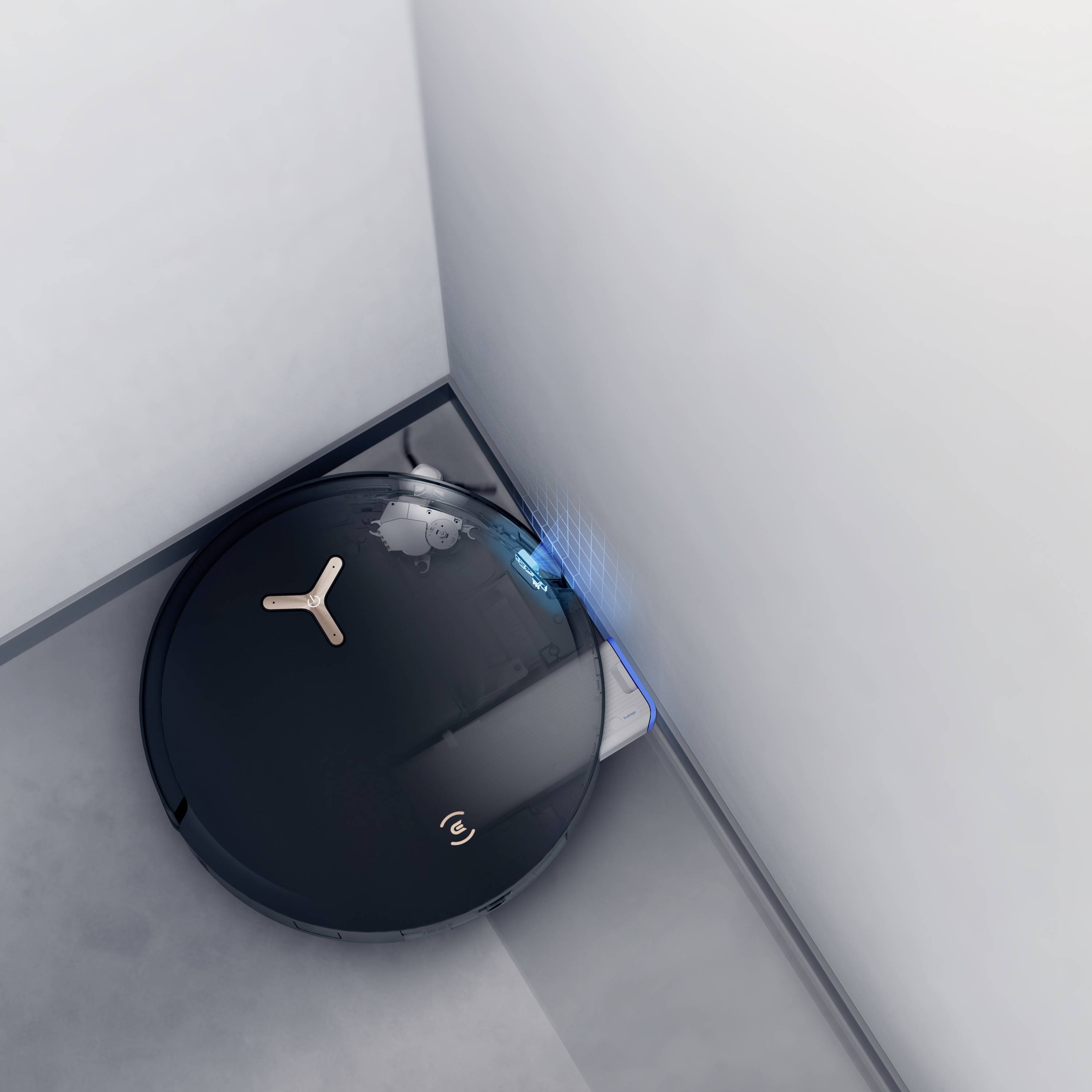 Ein schwarzer Saugroboter reinigt eine Ecke eines Raumes. Die blauen Lichter zeigen an, dass der Roboter in Betrieb ist.