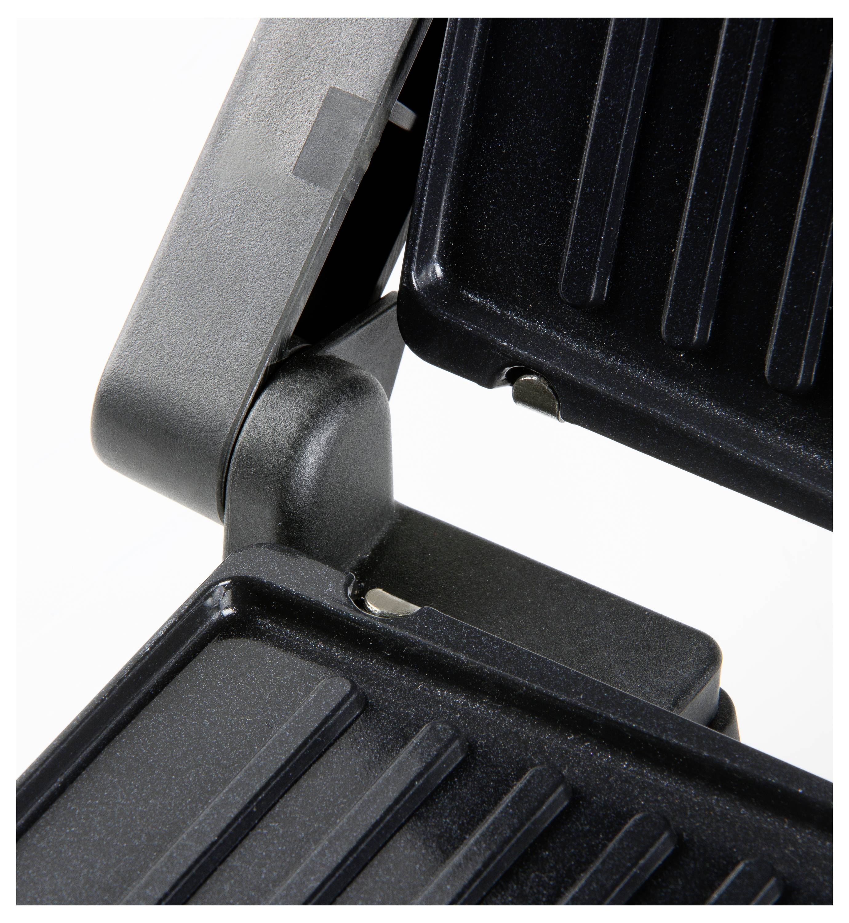 Nahaufnahme eines schwarzen Grills mit gerippten Platten, die geschlossen sind. Geeignet zum Grillen oder Toasten von Lebensmitteln.