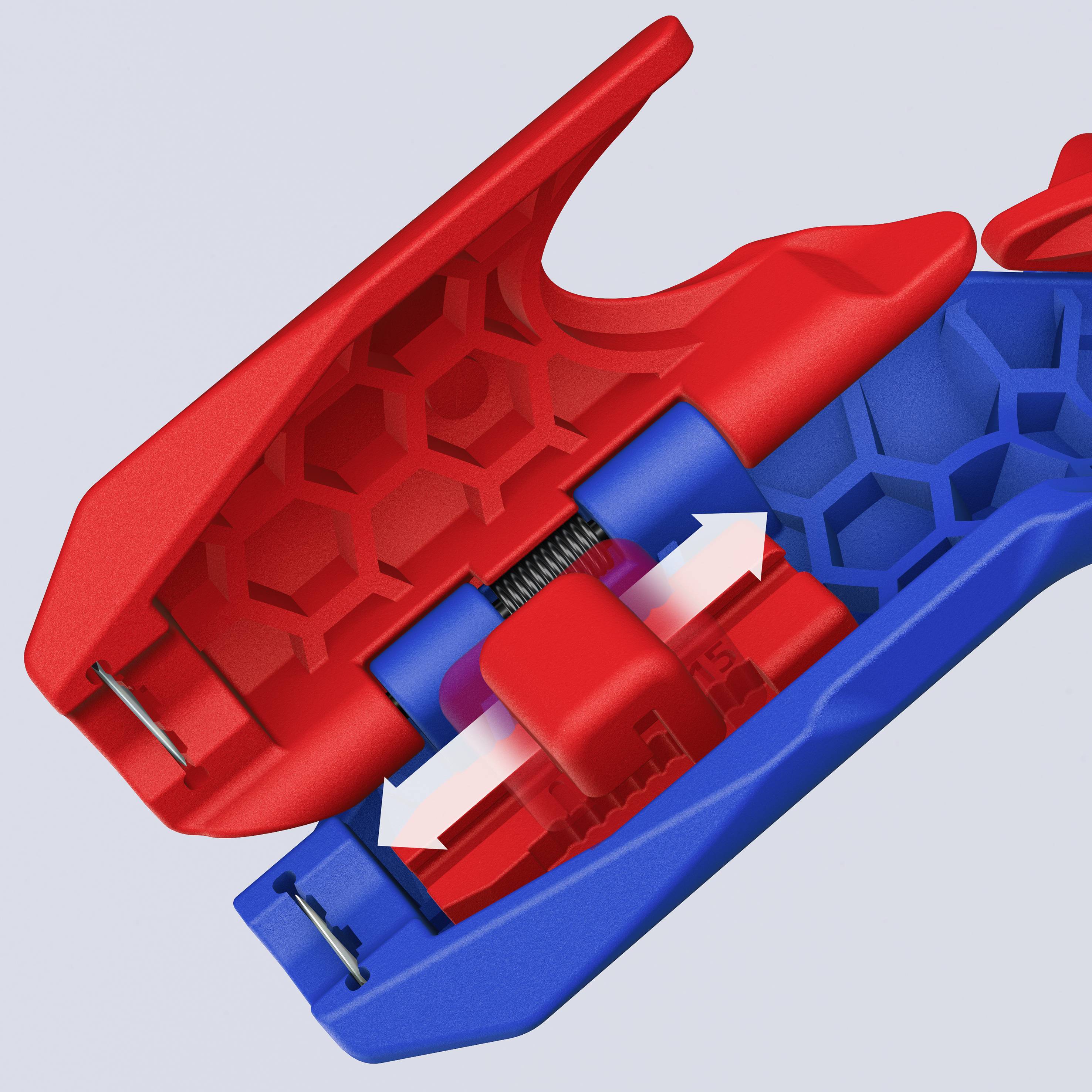 Ein rotes und blaues Plastikteil mit mechanischer Feder und weißen Pfeilen zeigt den Druckmechanismus.