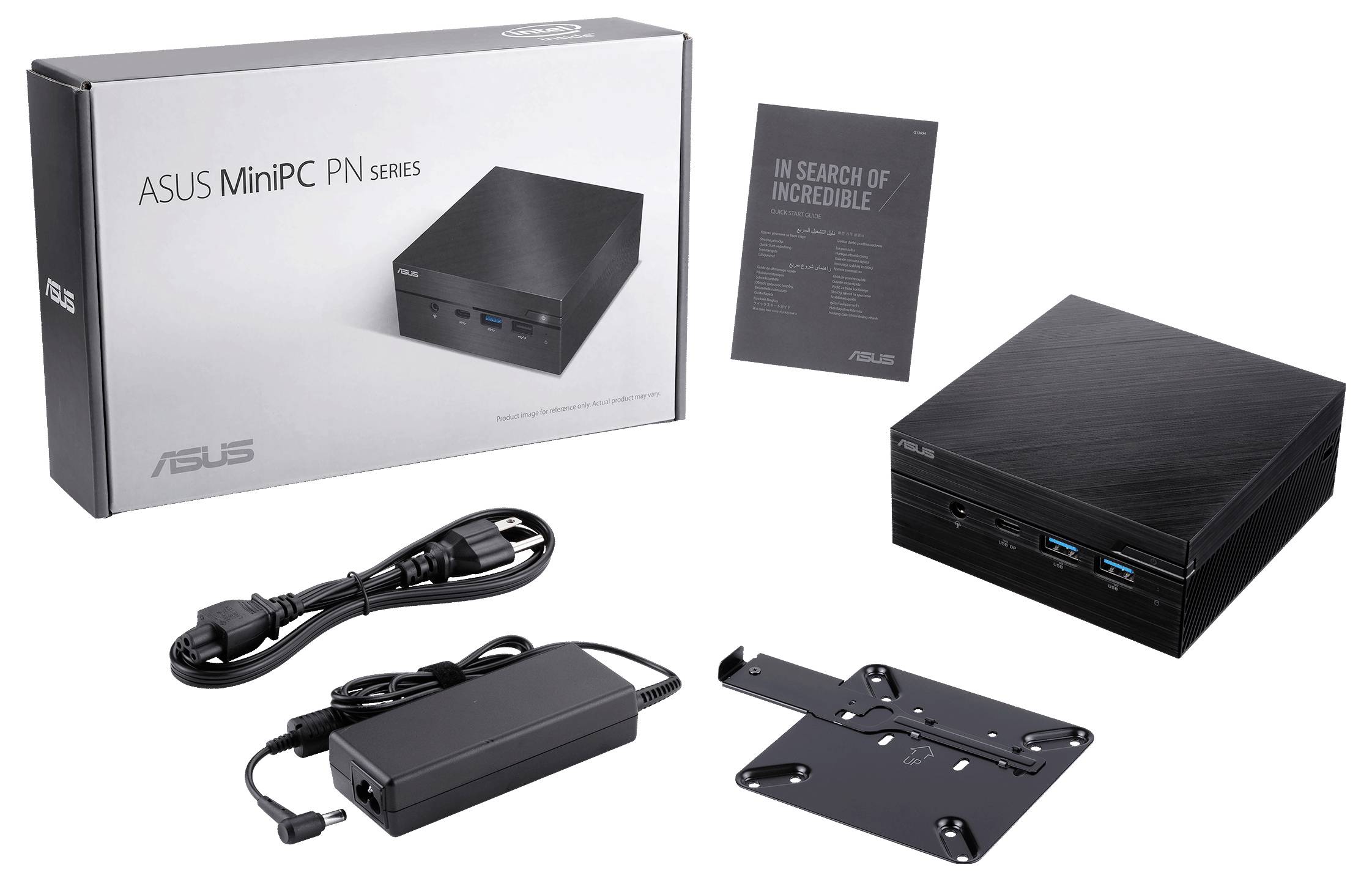 Ein Mini-PC von ASUS mit Verpackung, Netzteil, Kabel und Wandhalterung. Neben dem PC liegt ein Prospekt mit der Aufschrift 'In Search of Incredible'.