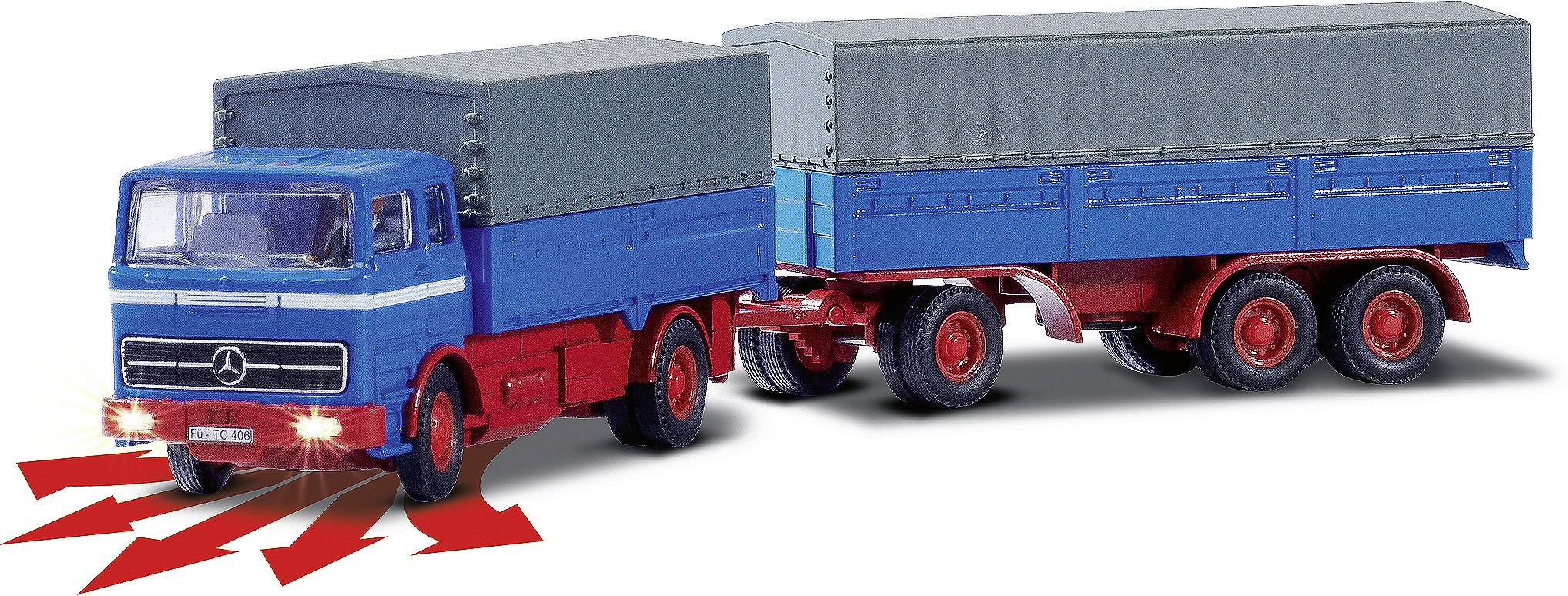 Ein blauer Lastwagen mit rotem Anhänger und grauer Plane. Scheinwerfer strahlen nach vorn. Modell zeigt LKW-Zugvorrichtung.