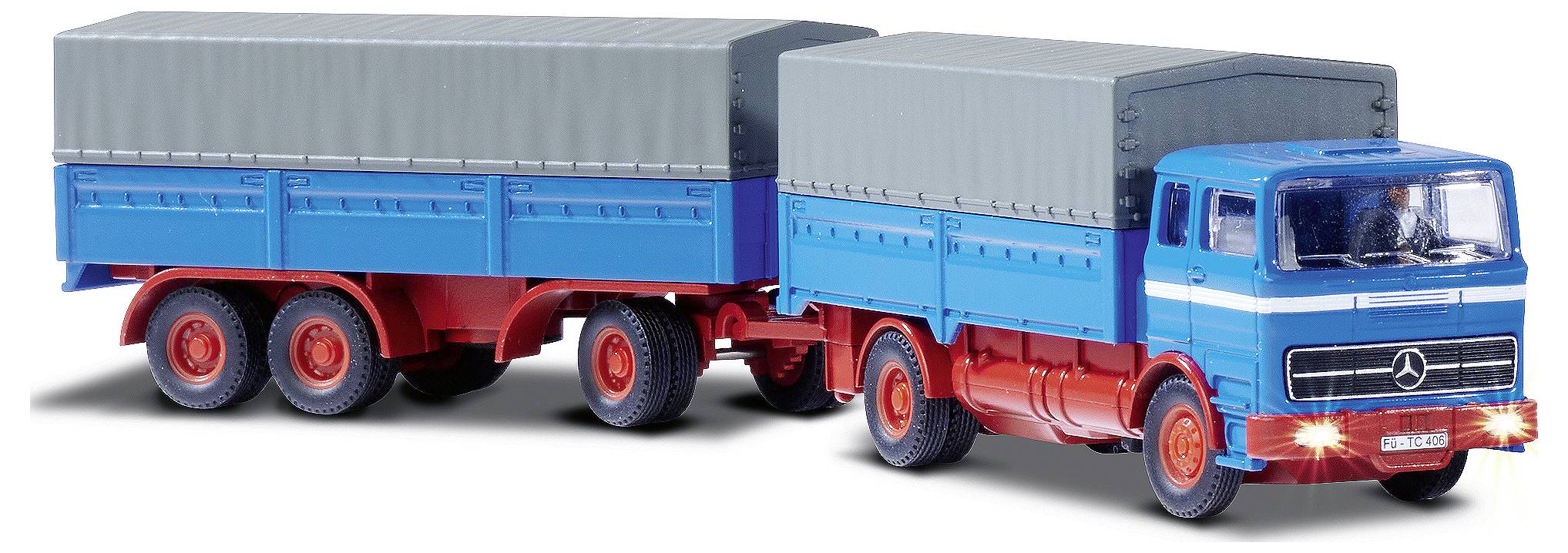 Ein Modell-Lkw mit Anhänger in blau und rot. Der Lkw hat eine grau abgedeckte Ladefläche. Der Anhänger hat eine ähnlich graue Plane.