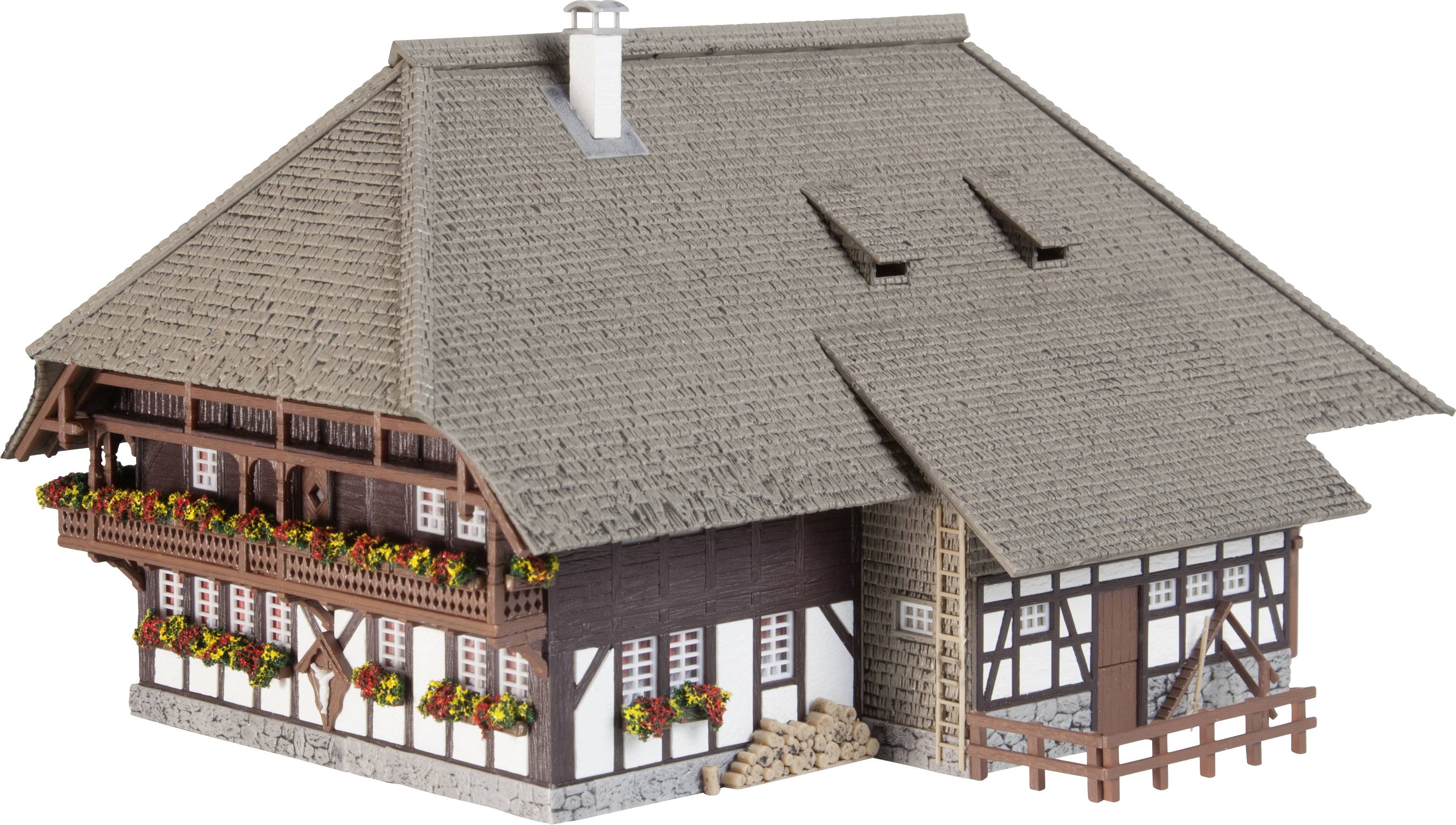 Traditionelles Fachwerkhaus mit großem Dach, Balkonen und Blumen an den Fenstern, symbolisiert ländlichen Charme in Deutschland.