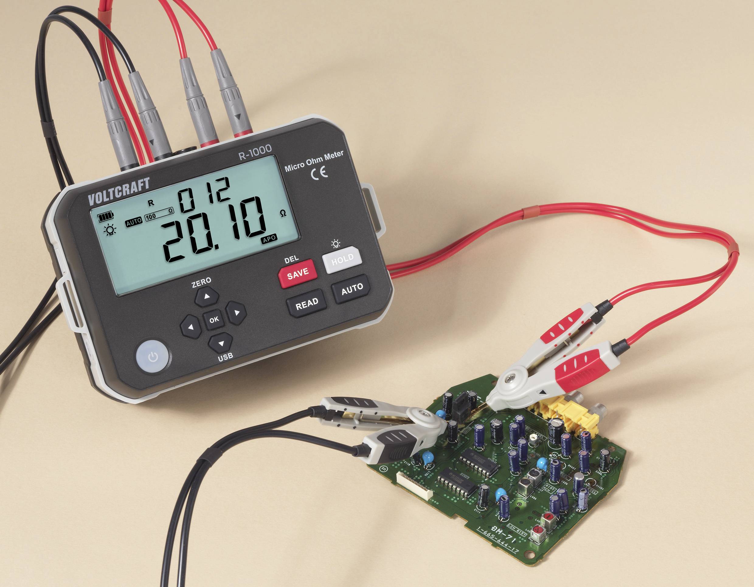 Ein digitales Multimeter mit angeschlossenen Kabeln zeigt die Ablesung '20,10' und ist mit einer elektronischen Leiterplatte mit verschiedenen Komponenten verbunden.