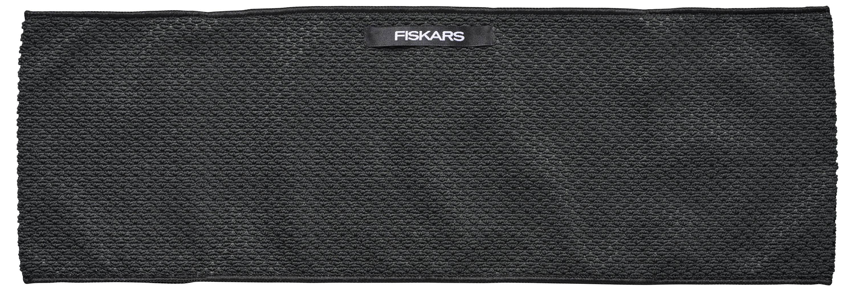 Schwarzer, rechteckiger Schleifsteinaufsatz mit strukturierter Oberfläche und Markenlabel 'Fiskars' in der Mitte oben.
