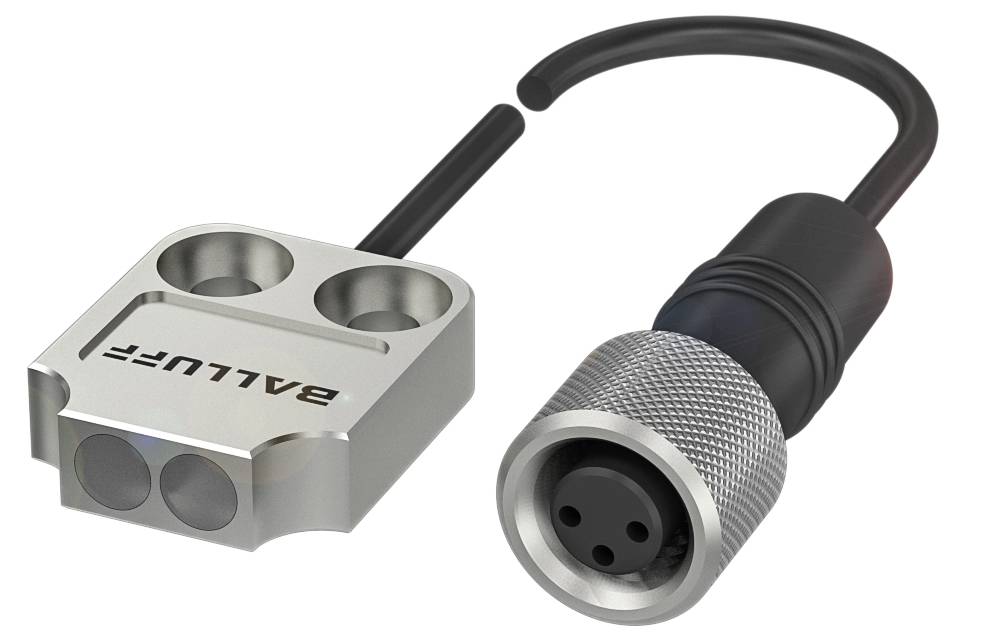 Ein silbernes, metallisches Gerät mit dem Text 'BALLUFF' neben einem schwarzen Kabel mit rundem Stecker.