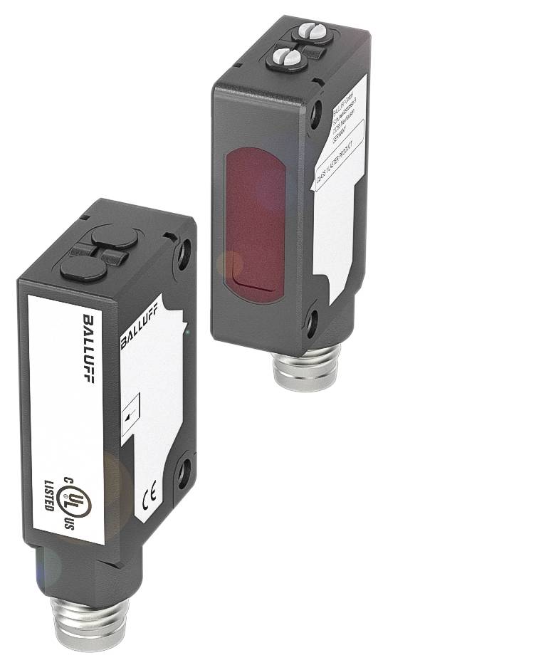 Zwei rechteckige elektrische Sensoren mit schwarzem Gehäuse und weißen Labels, eine rote Oberfläche sichtbar auf dem rechten Sensor.
