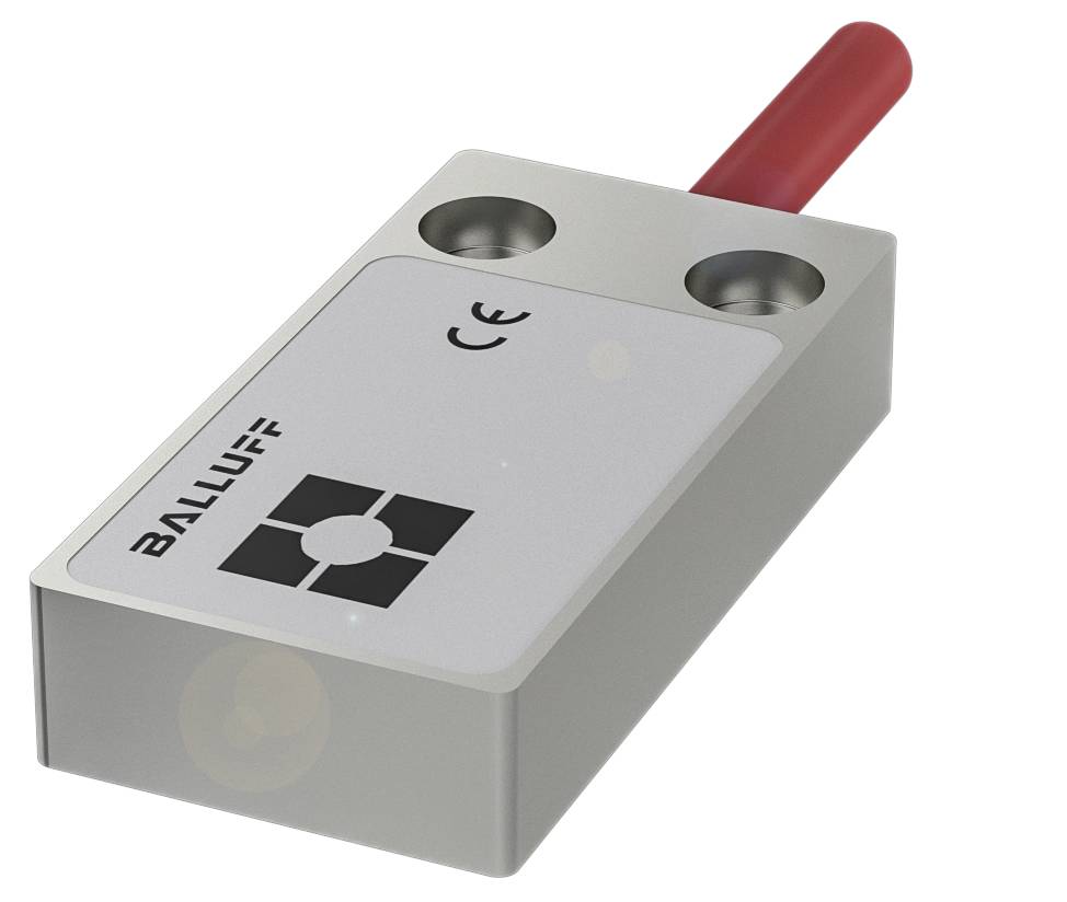 Sensorgerät mit rechteckigem Gehäuse, grauer Oberfläche und rotem Kabelanschluss. Aufdruck 'BALLUFF' und CE-Zeichen. Links oben im Bild.