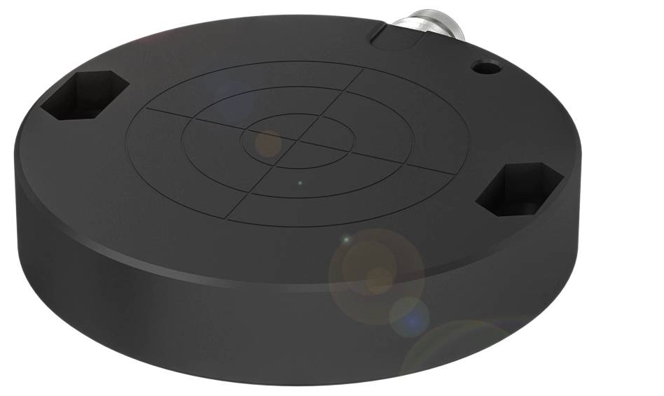 Rundes, schwarzes Gerät mit konzentrischen Kreisen auf der Oberfläche und einem Metallanschluss an der Seite.