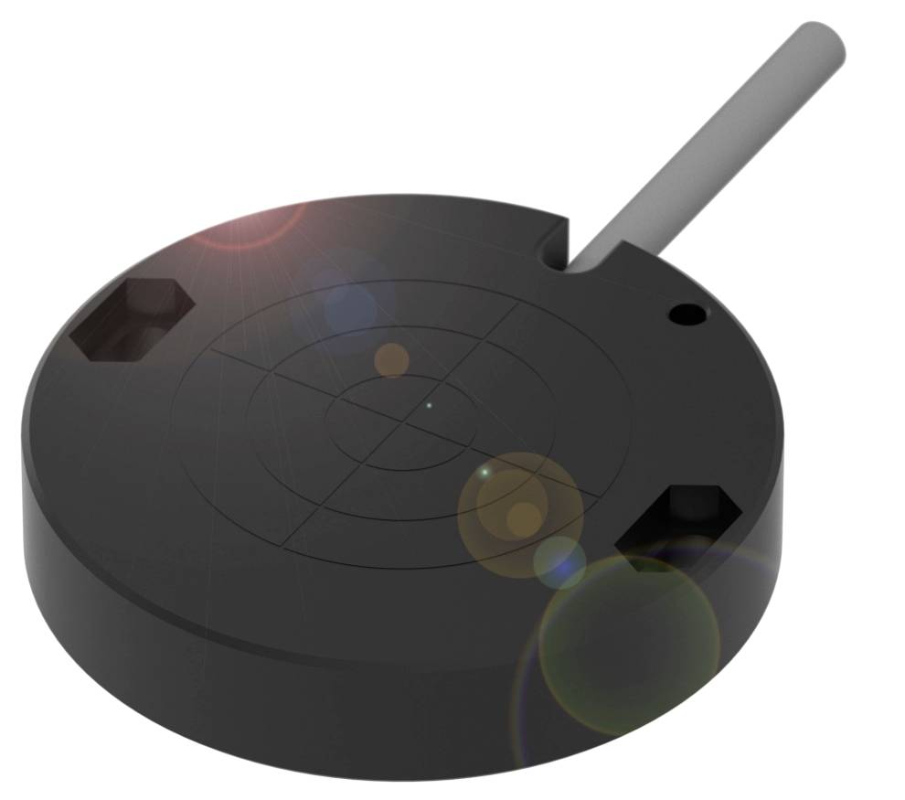 Ein schwarzer, runder Gegenstand mit einer glatten Oberfläche und einer abstehenden grauen Stange an der Seite, eventuell Teil eines technischen Geräts.