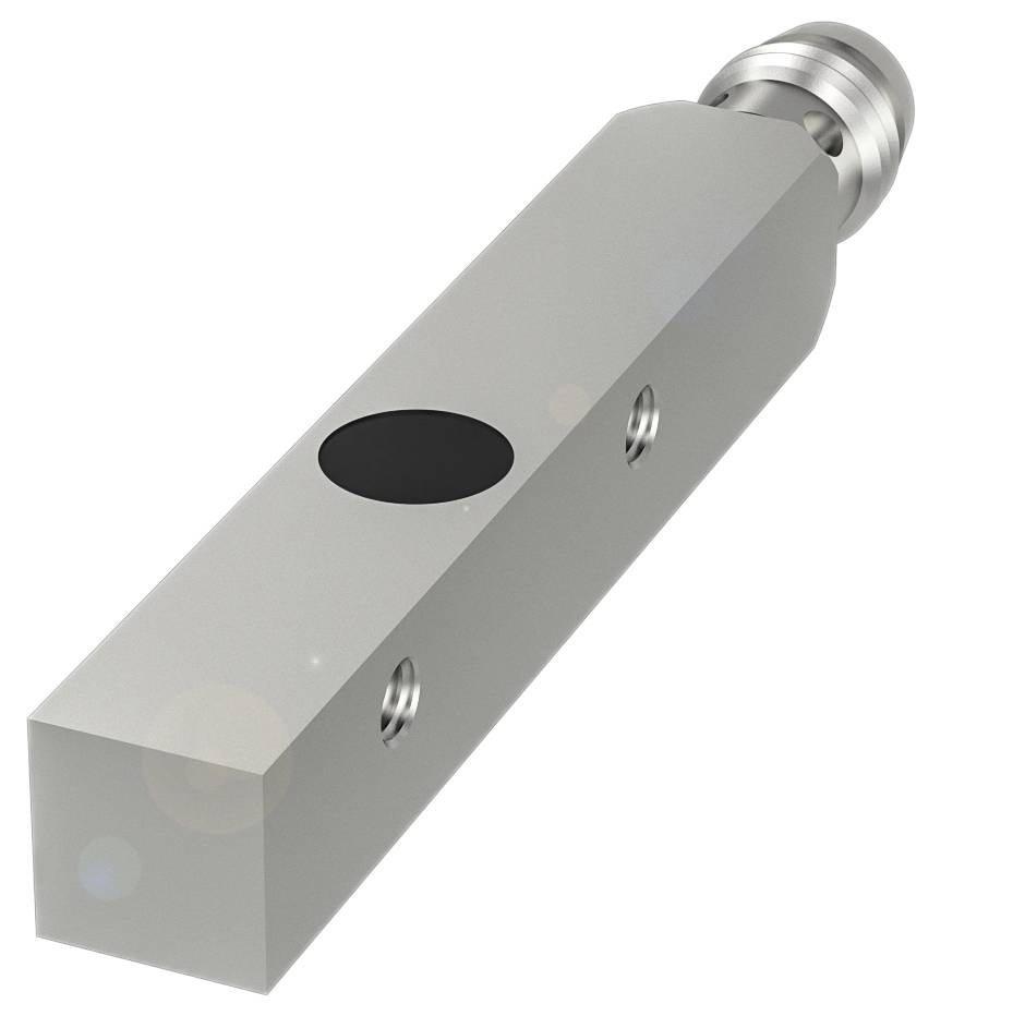 Ein rechteckiger Metallblock mit runder schwarzer Fläche und zylindrischem Ende, möglicherweise ein Maschinenteil oder Sensor.