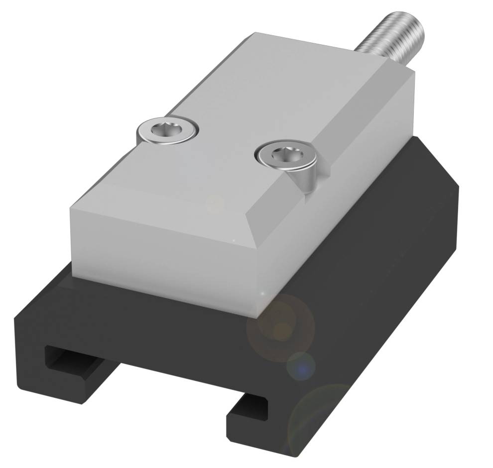 Ein rechteckiger Metallblock mit Schrauben auf einer schwarzen Basis, möglicherweise Teil eines technischen oder mechanischen Systems.