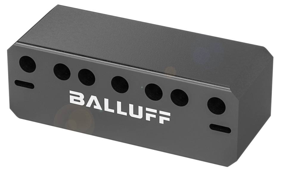 Ein rechteckiges, schwarzes Bauteil mit mehreren runden Öffnungen und dem weißen Schriftzug 'Balluff'.