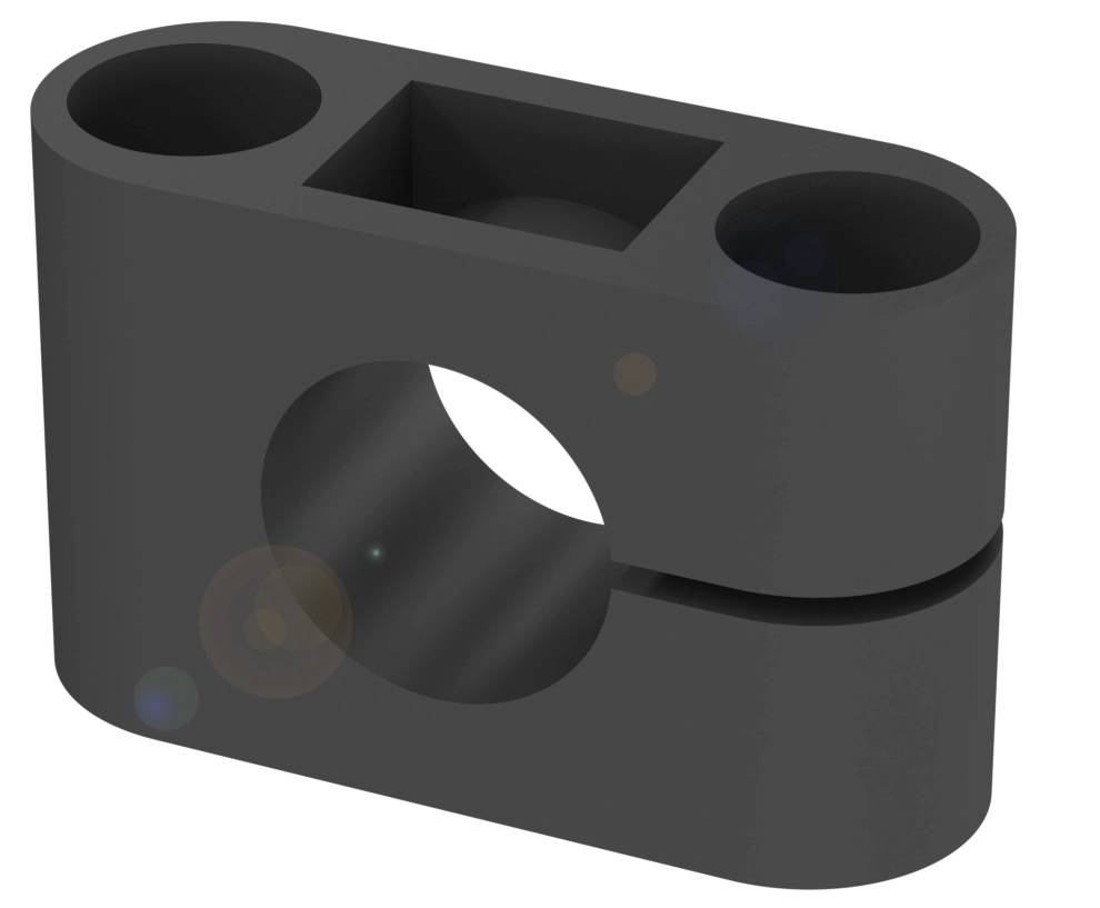 Ein rechteckiger schwarzer Kunststoffblock mit zwei runden und einer quadratischen Öffnung, sowie einem schlitzartigen Schnitt.