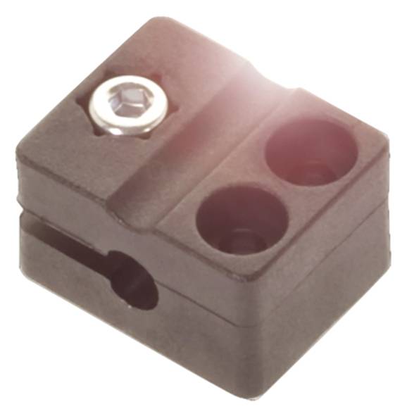 Ein rechteckiges, schwarzes Kunststoffbauteil mit zwei runden Öffnungen und einer Schraube oben links.