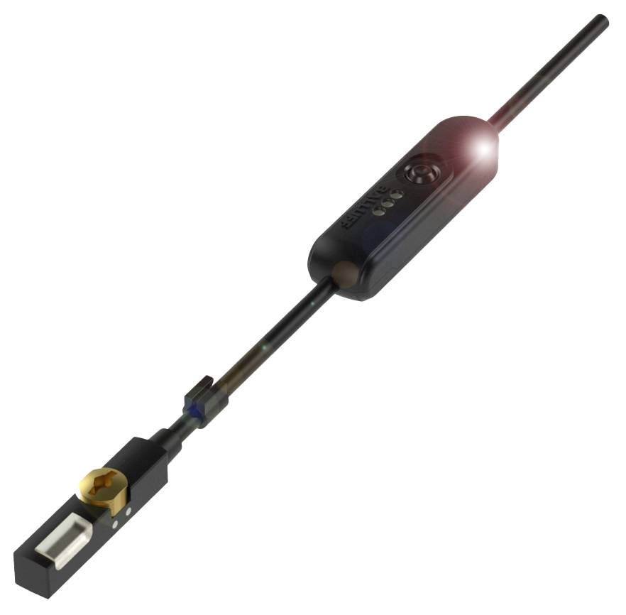 Ein schwarzes technisches Gerät mit einem langen Stab und einer rechteckigen Basis. Oberseite hat eine runde, beleuchtete Stelle.