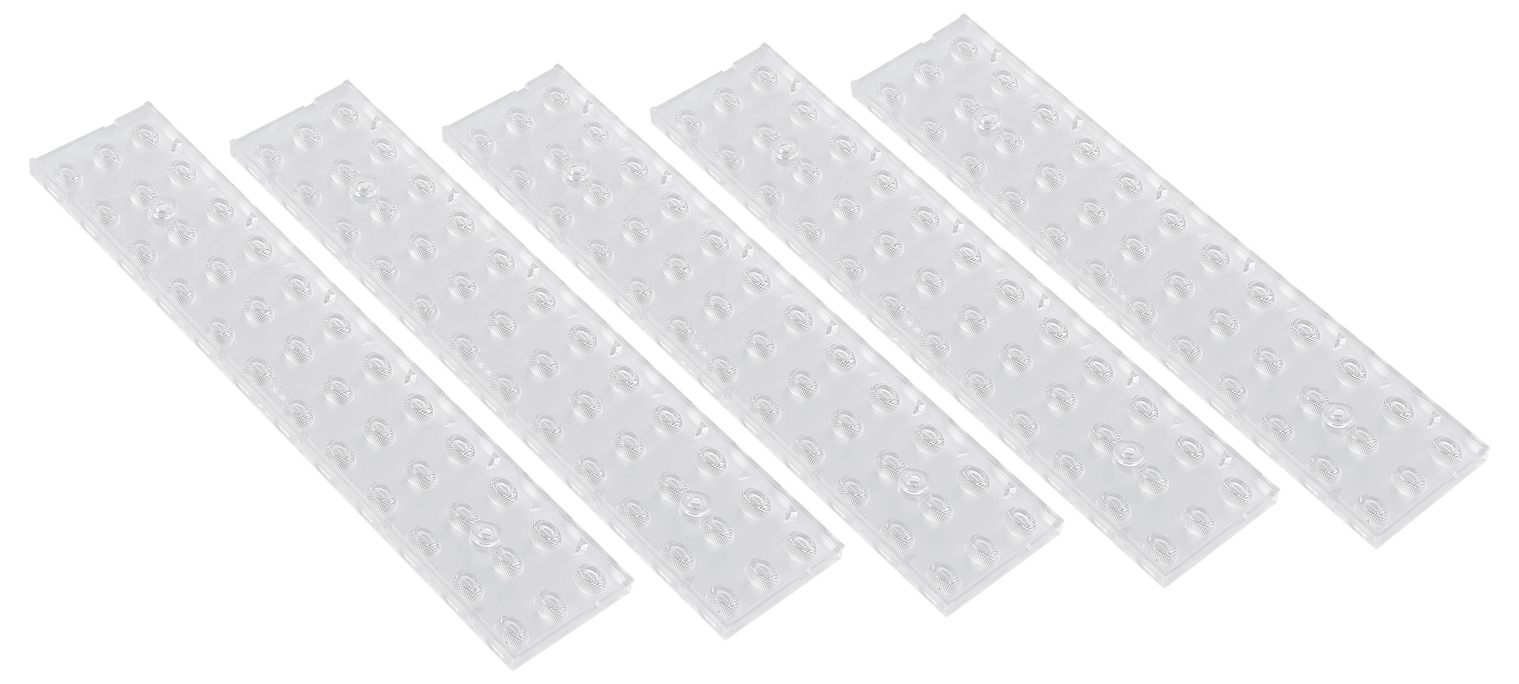 Fünf längliche, transparente Plastikstreifen mit runden Erhöhungen, die nebeneinander angeordnet sind.