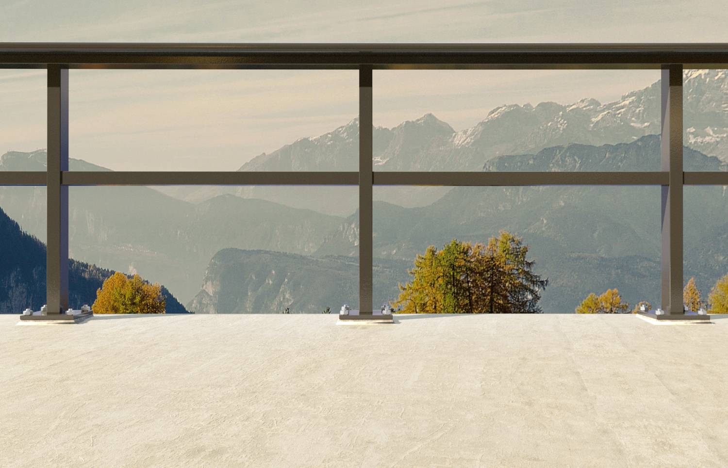Eine Betonterrasse bietet Ausblick auf eine malerische Berglandschaft mit herbstlichen Bäumen und fernen Gipfeln unter einem klaren Himmel.