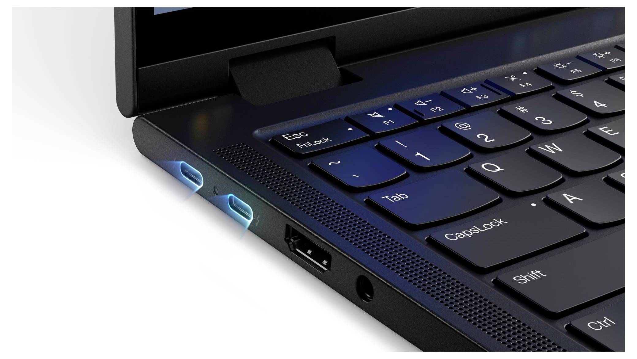 Eine Nahaufnahme der Tastatur und Anschlüsse eines Laptops, die USB- und Audioports zeigt, mit Fokus auf das Kantendesign und den blauen Beleuchtungseffekt.