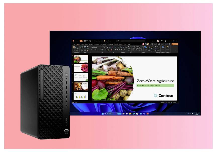 Ein Computermonitor zeigt eine Präsentation mit dem Titel Zero-Waste Agriculture, während ein Desktop-PC links daneben vor einem rosa Hintergrund steht.