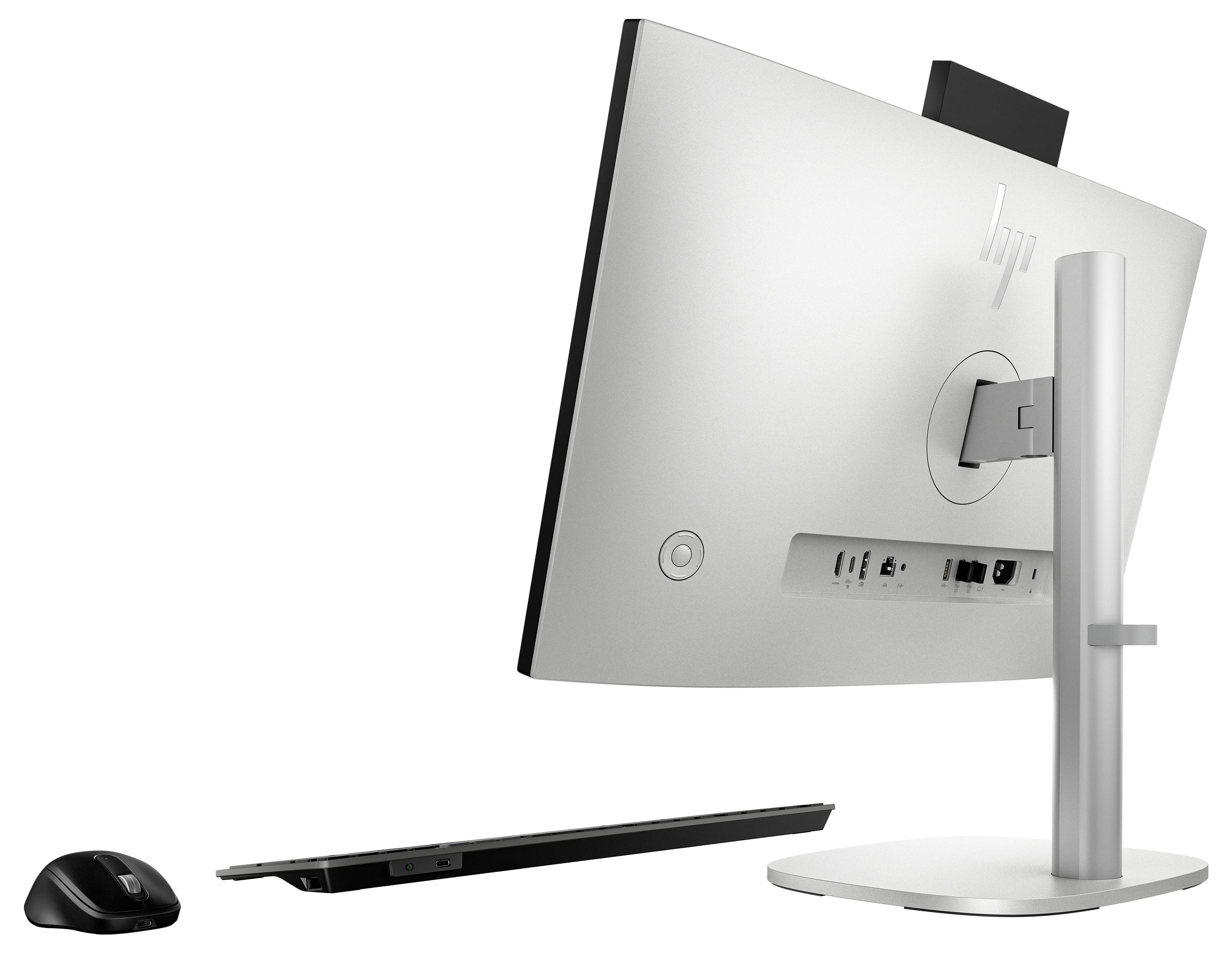 Ein modernes Desktop-Computer-Setup, von hinten betrachtet, mit Anschlüssen; inklusive einer drahtlosen Maus und Tastatur.